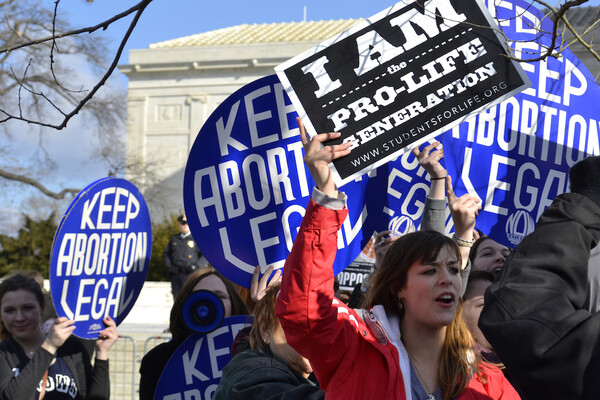 Protesters both pro- and anti-choice holding signs in Washington D.C.