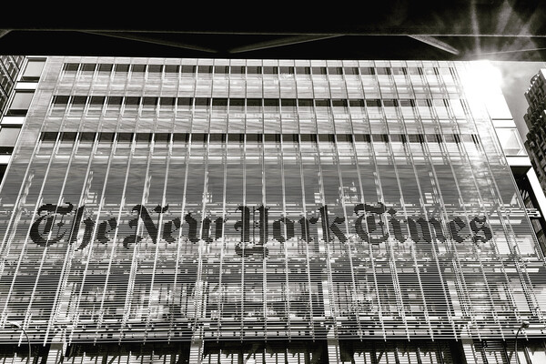 The front of the New York Times building at night.
