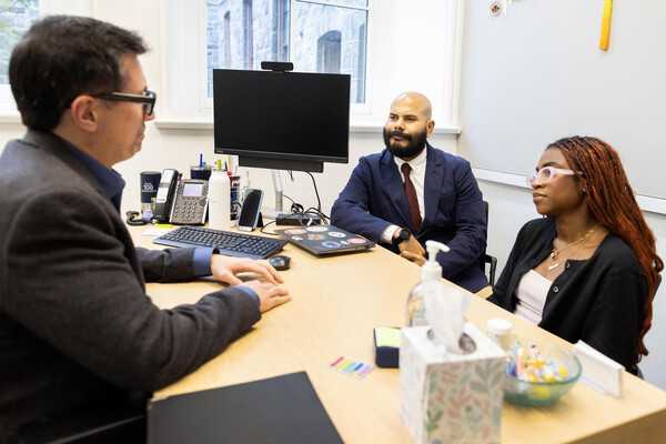 Marc Lo (left) and Enmanuel Martínez (center) speaking with Mayokun Omitogun (right)