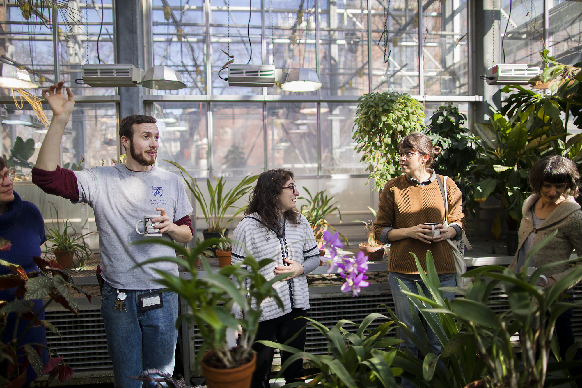 Gardeners standing together in a greenhouse