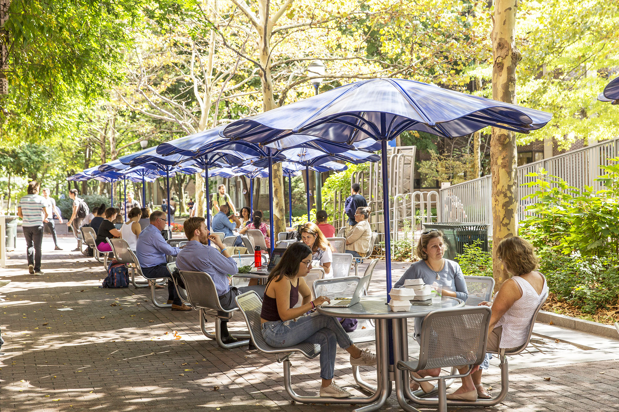 Umbrella tables and customers sitting on patio