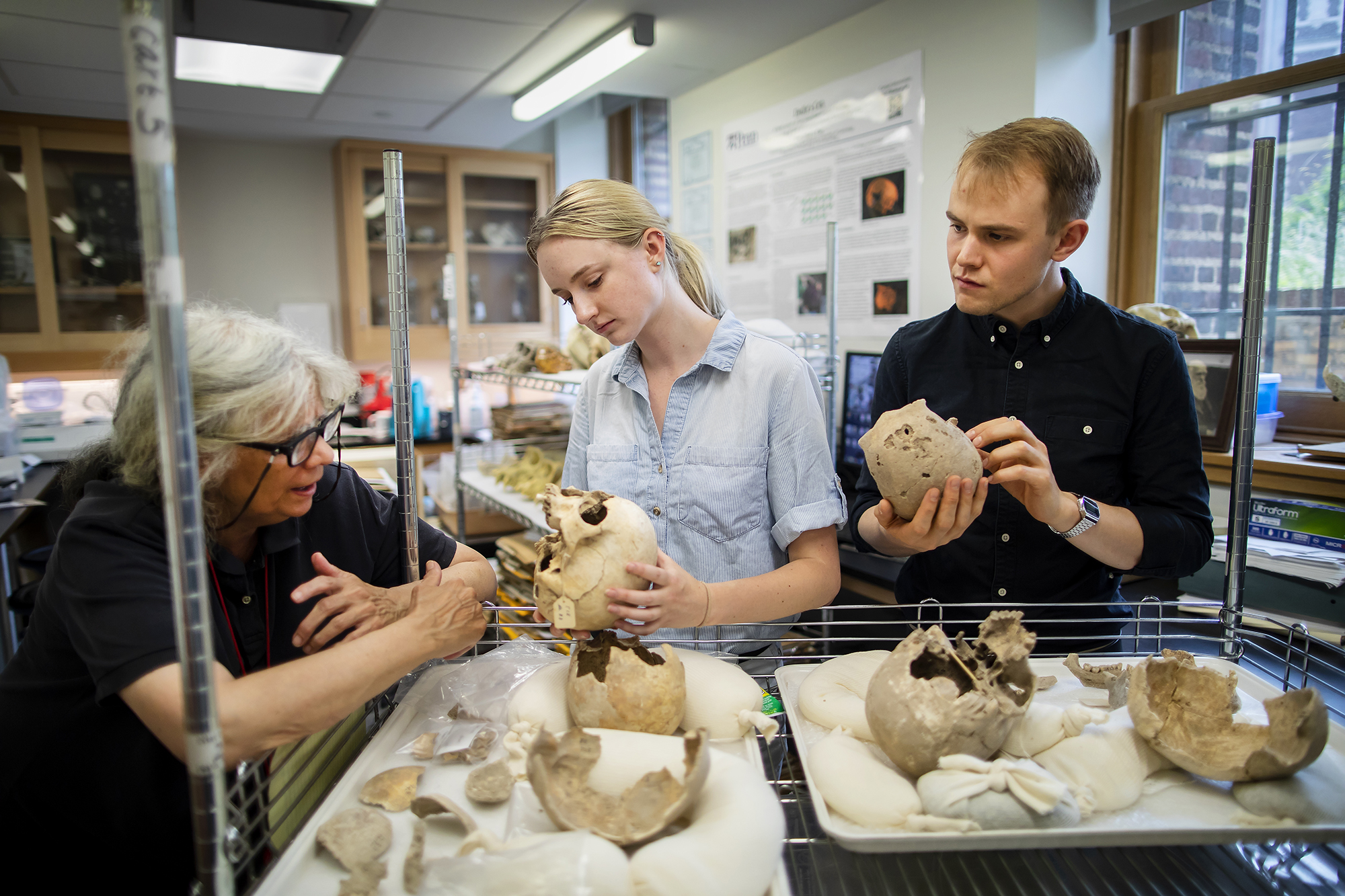 In the lab of Janet Monge (left), rising senior Fiona Jensen-Hitch is studying human remains from the ancient site of Gibeon, with help from doctoral candidate Paul Mitchell.