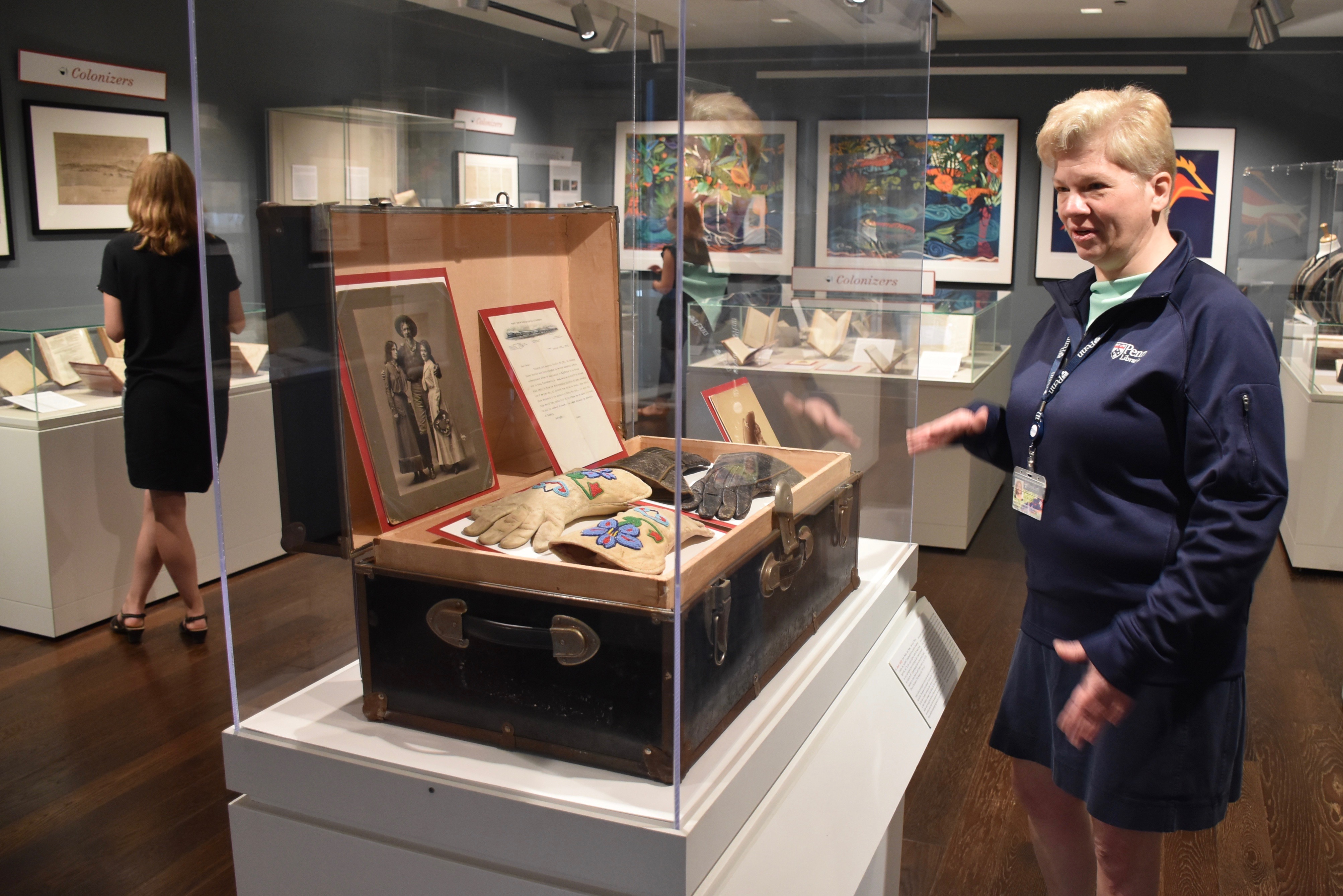 Penn-Libraries-Regan-Klastrup-with-Annie-Oakley-trunk-and-gloves-in-exhibition-on-women-in-the-American-wilderness