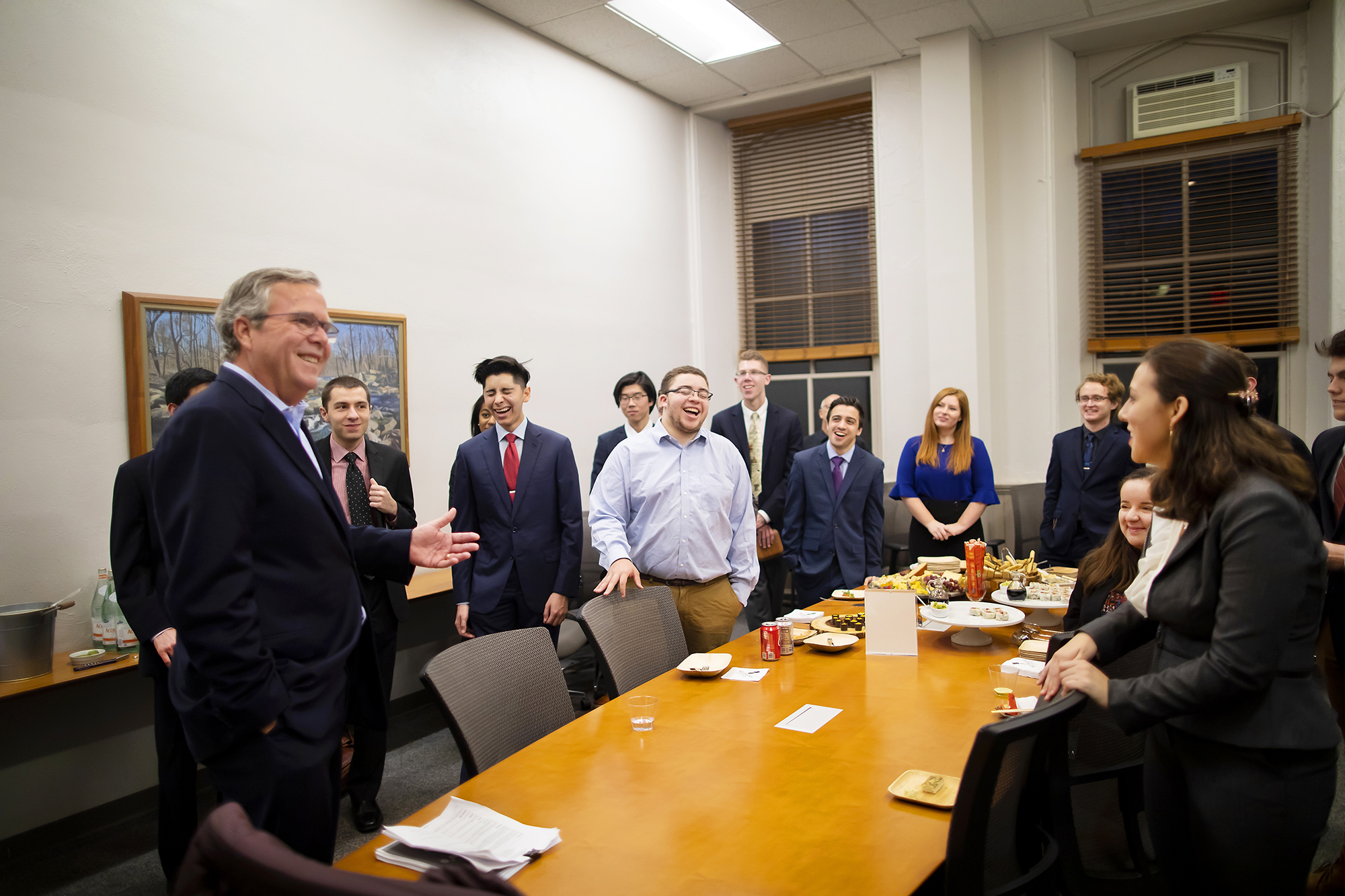 bush-standing-at-table-in-talking-with-students