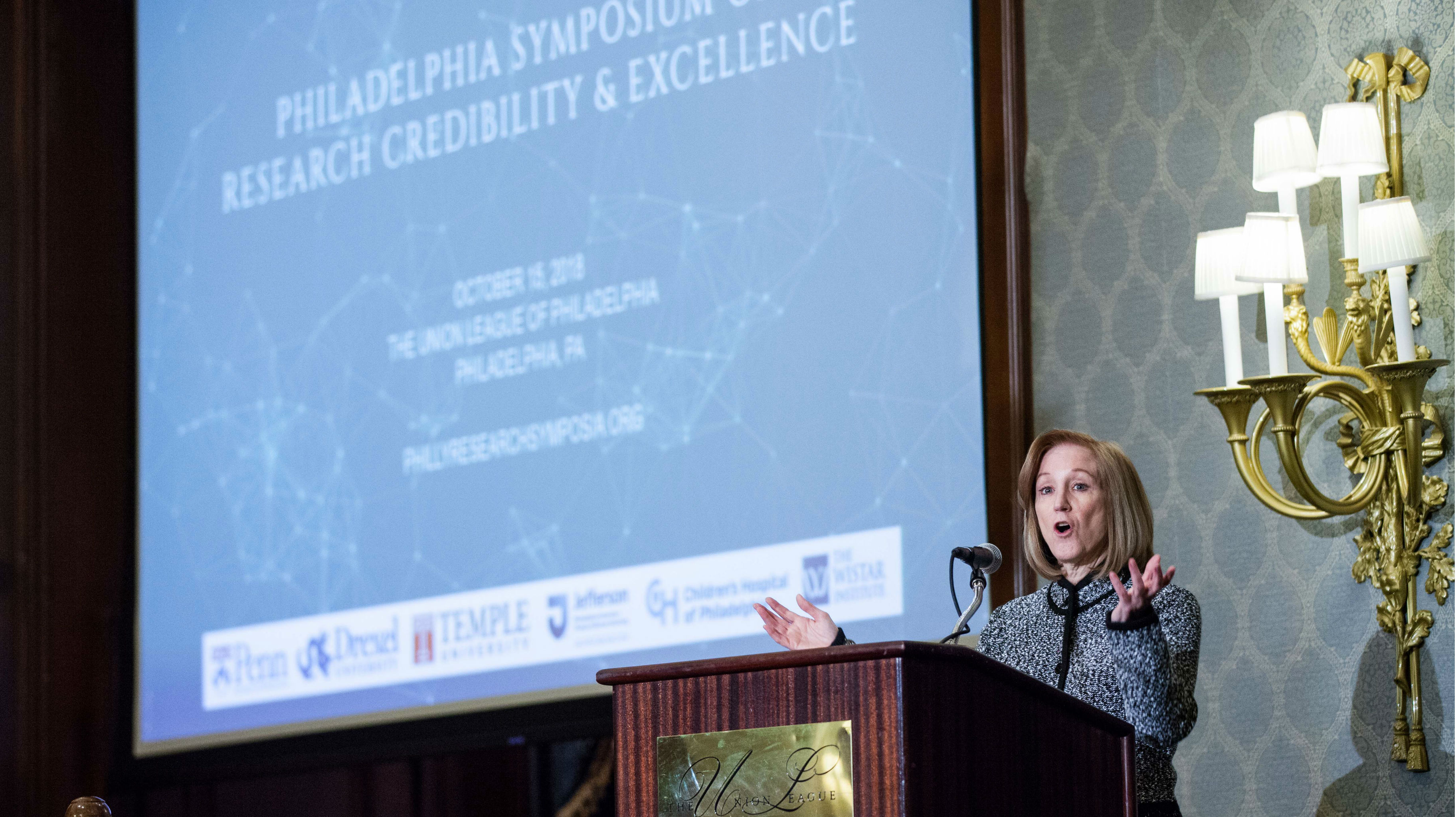 Dawn Bonnell, University of Pennsylvania's Vice Provost of Research, stands at a podium.