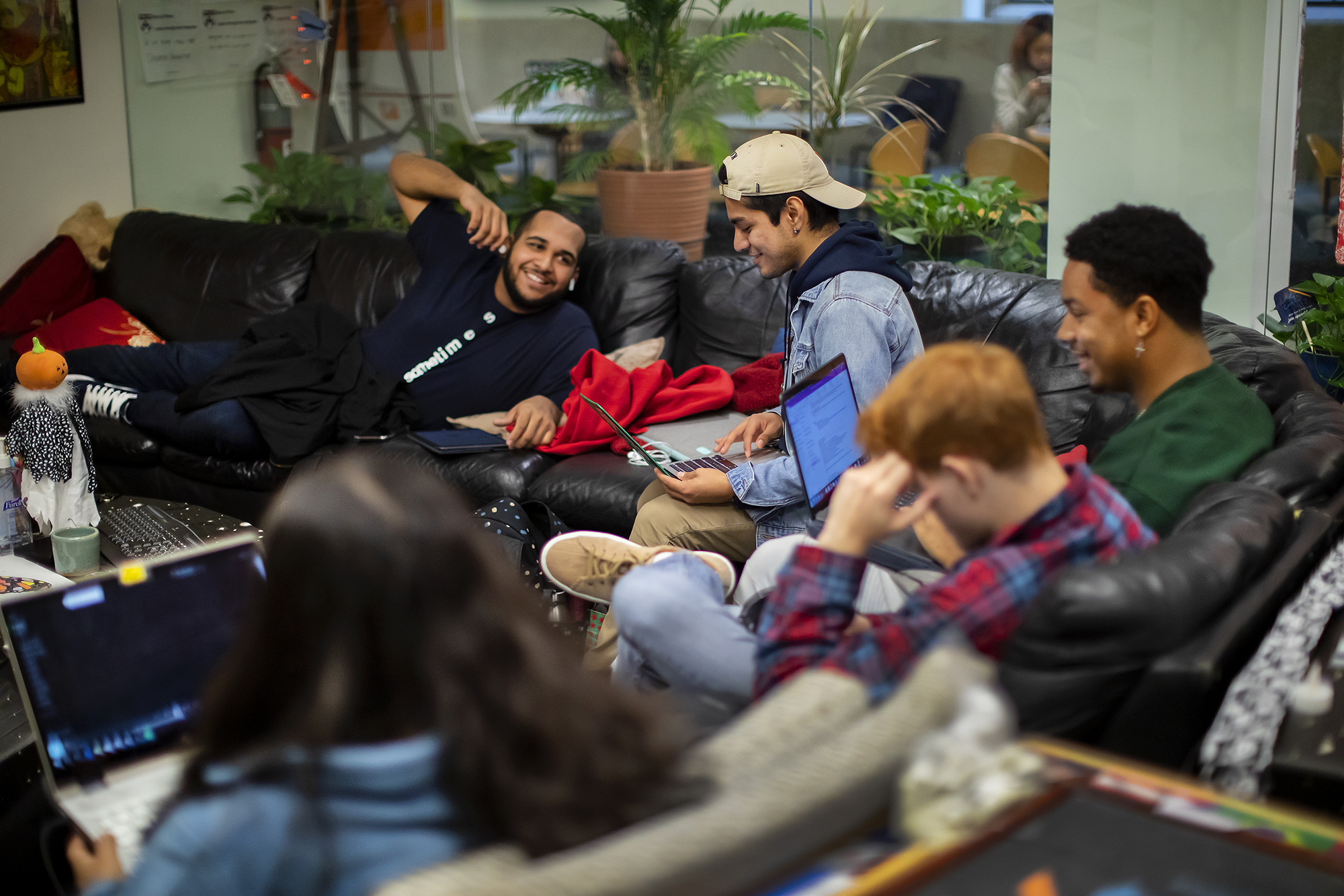 Students taking a break on the sofa at La Casa Latina