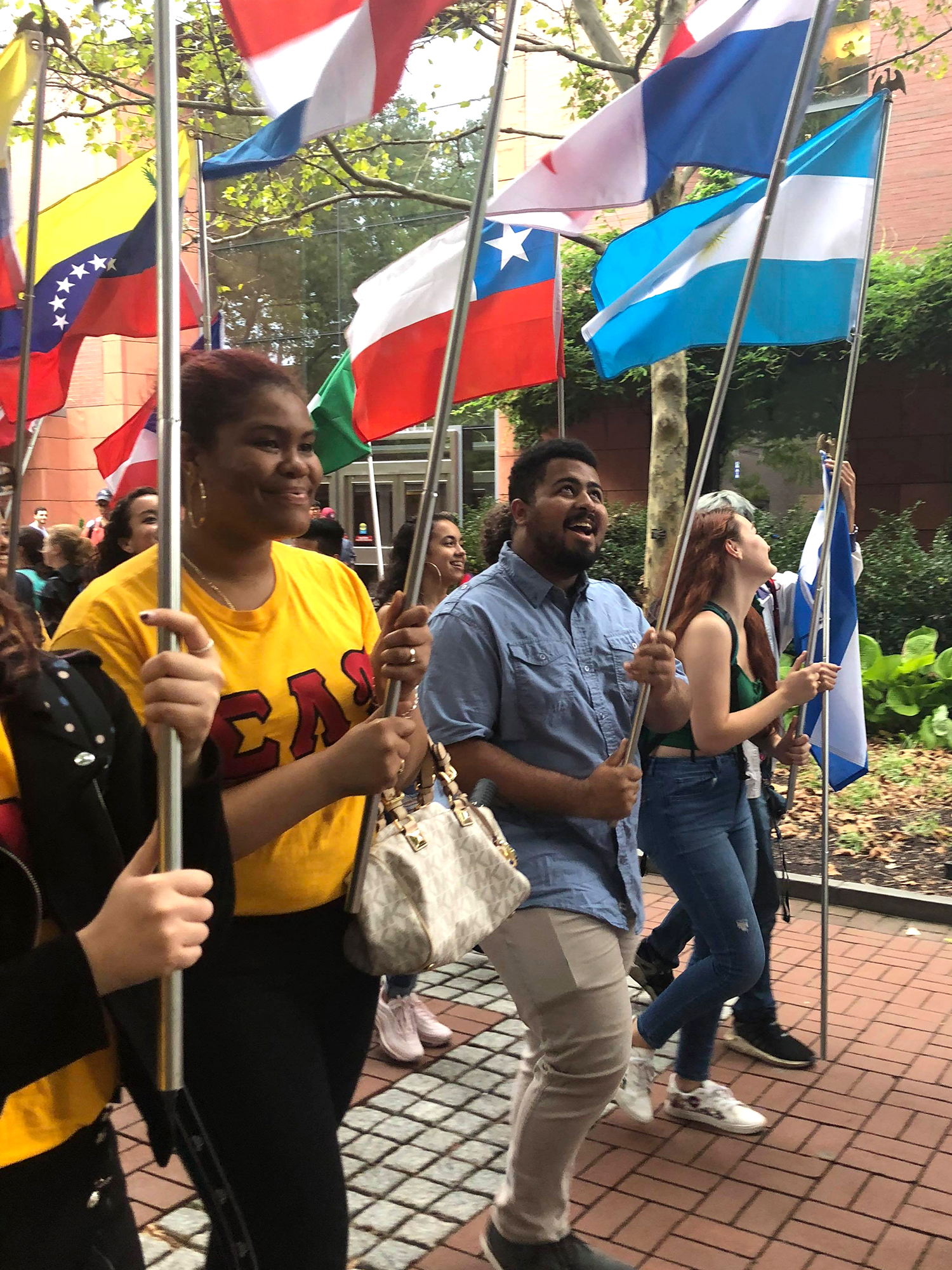 Hispanic Heritage march down Locust Walk with flags