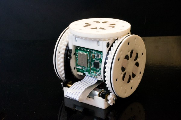Close up of one of the SMORES singular modules, which is a cube-shaped, wheeled robot