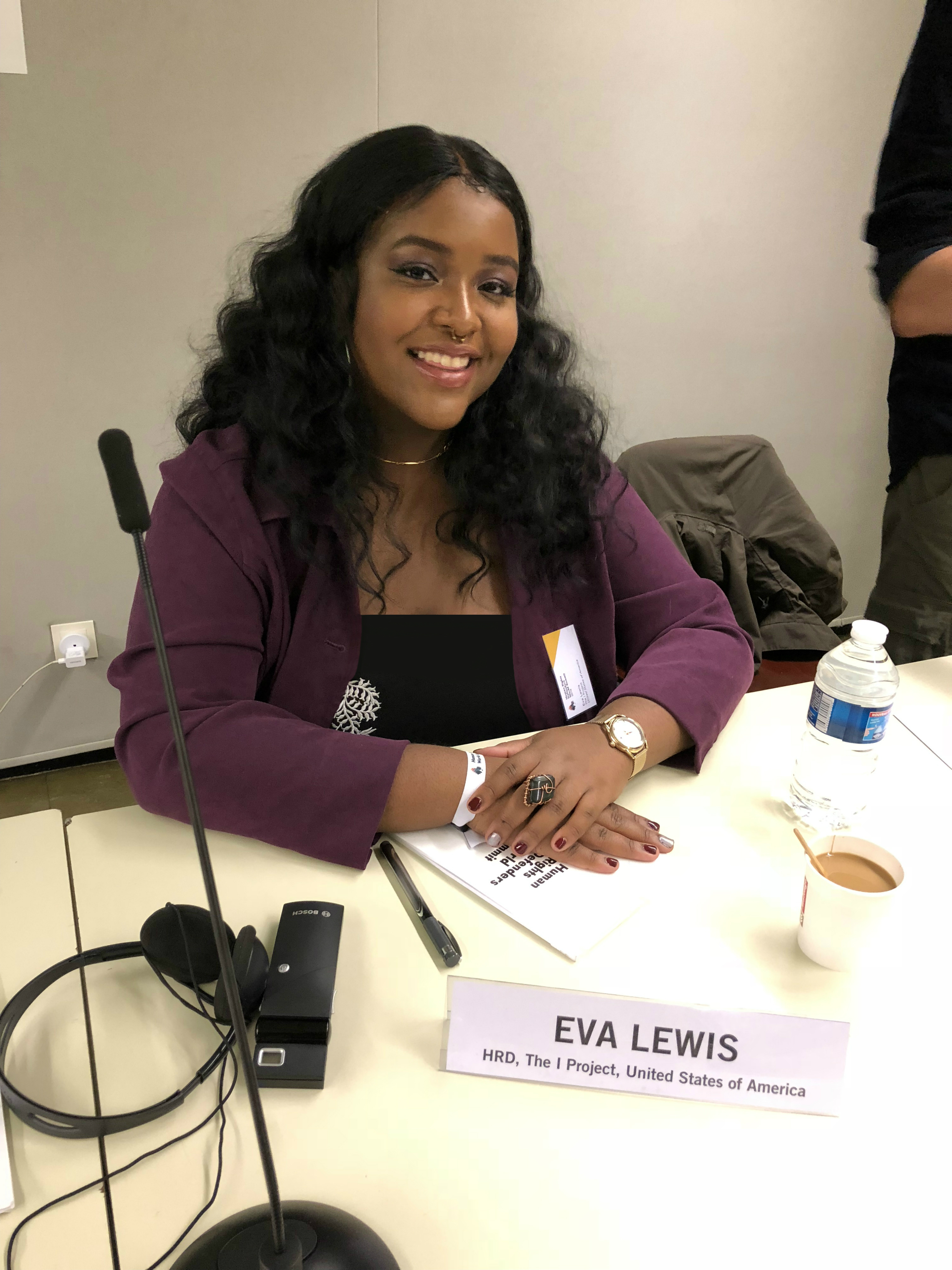 Eva Maria Lewis at a table at the Human Rights Summit in Paris 2018