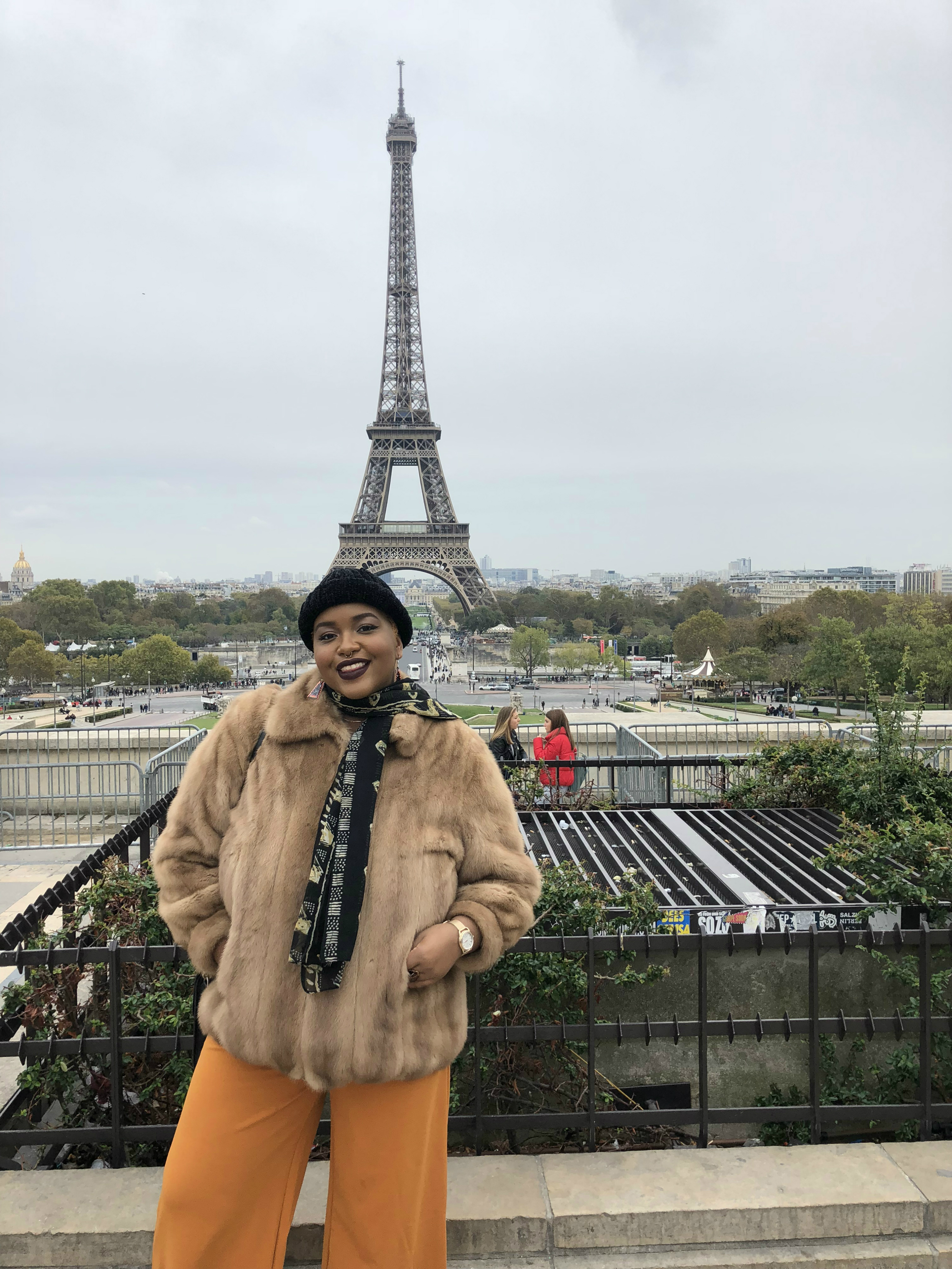 Eva Maria Lewis stands in front of the Eiffel Tower in Paris