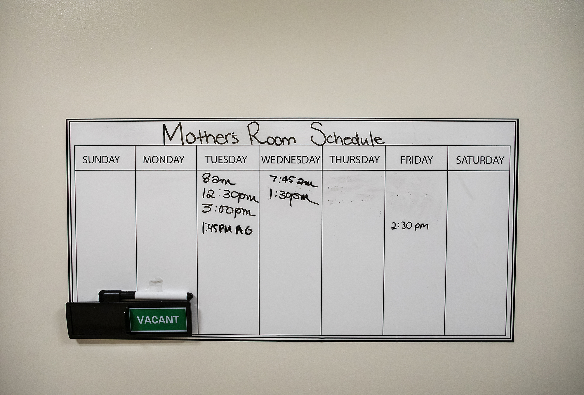 Whiteboard with seven days of the week, with writing on a schedule