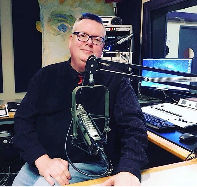 Robert at his radio desk with microphone