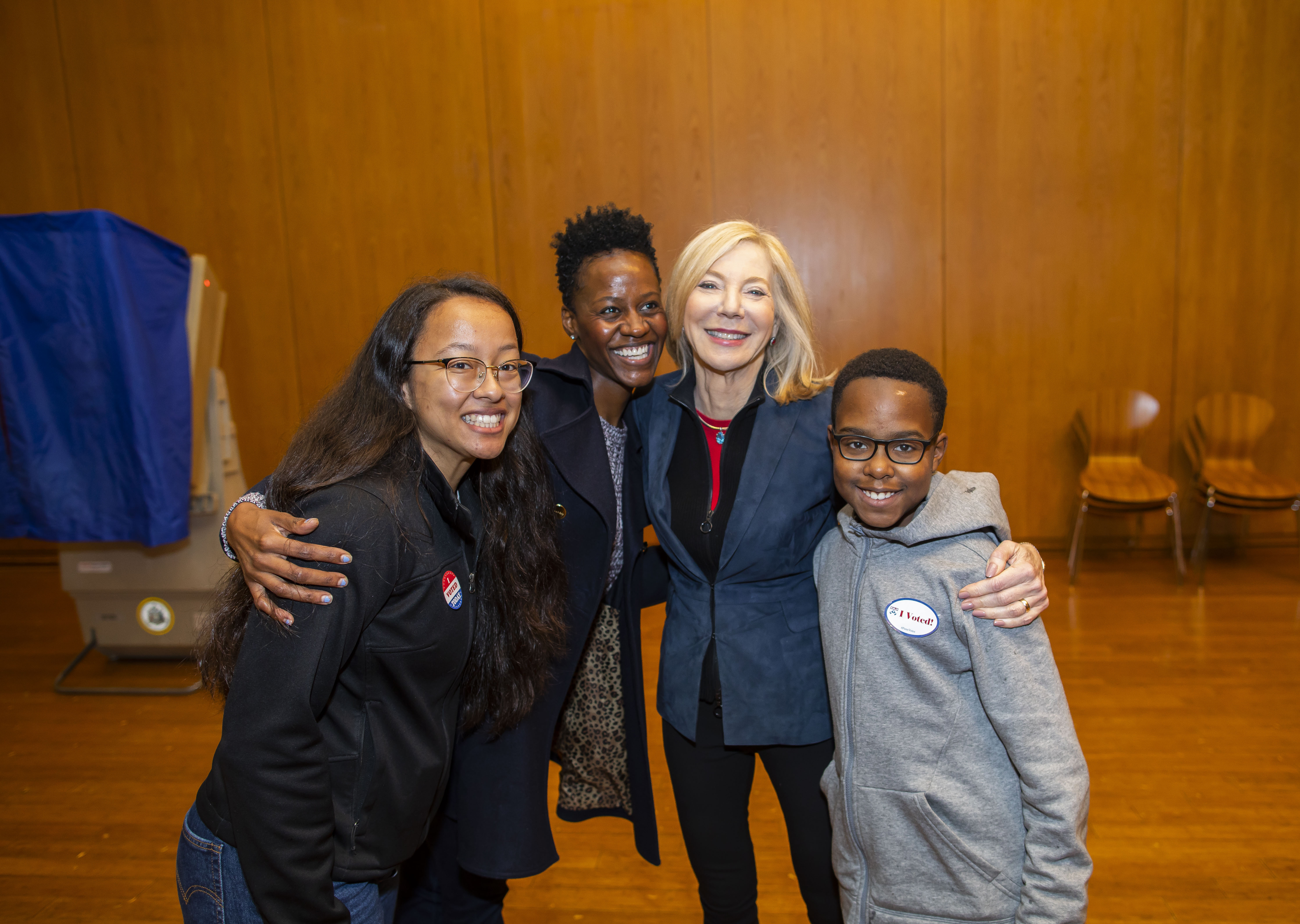 Dr. Gutmann poses for the camera with voters and a young boy at Vance Hall