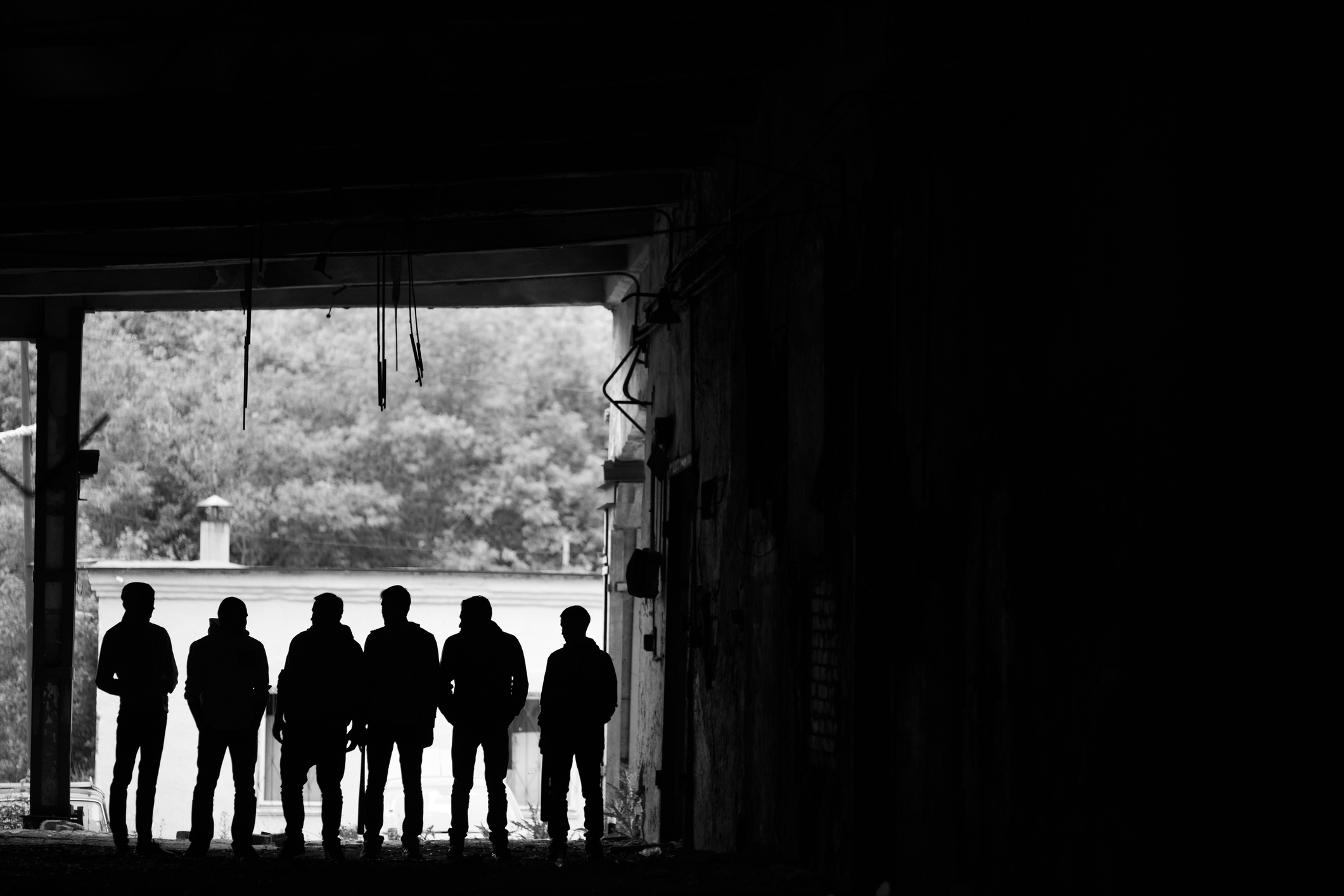 Outlines of men outside, in black and white