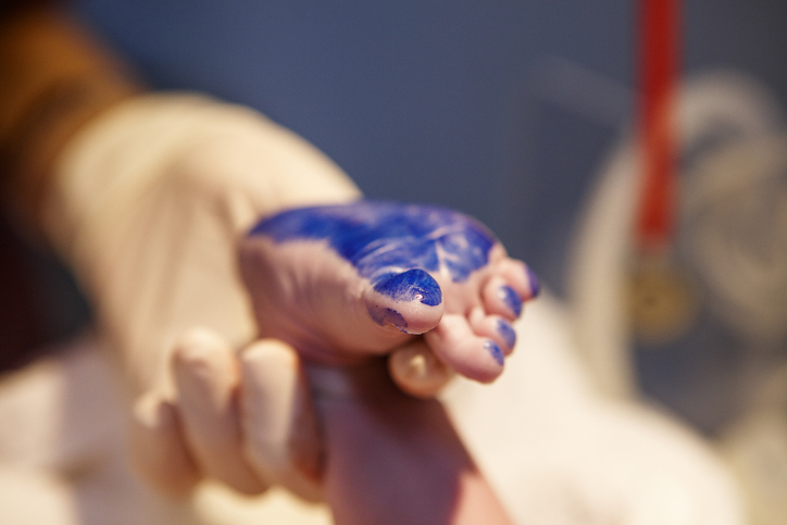 newborn foot with blue ink from footprint