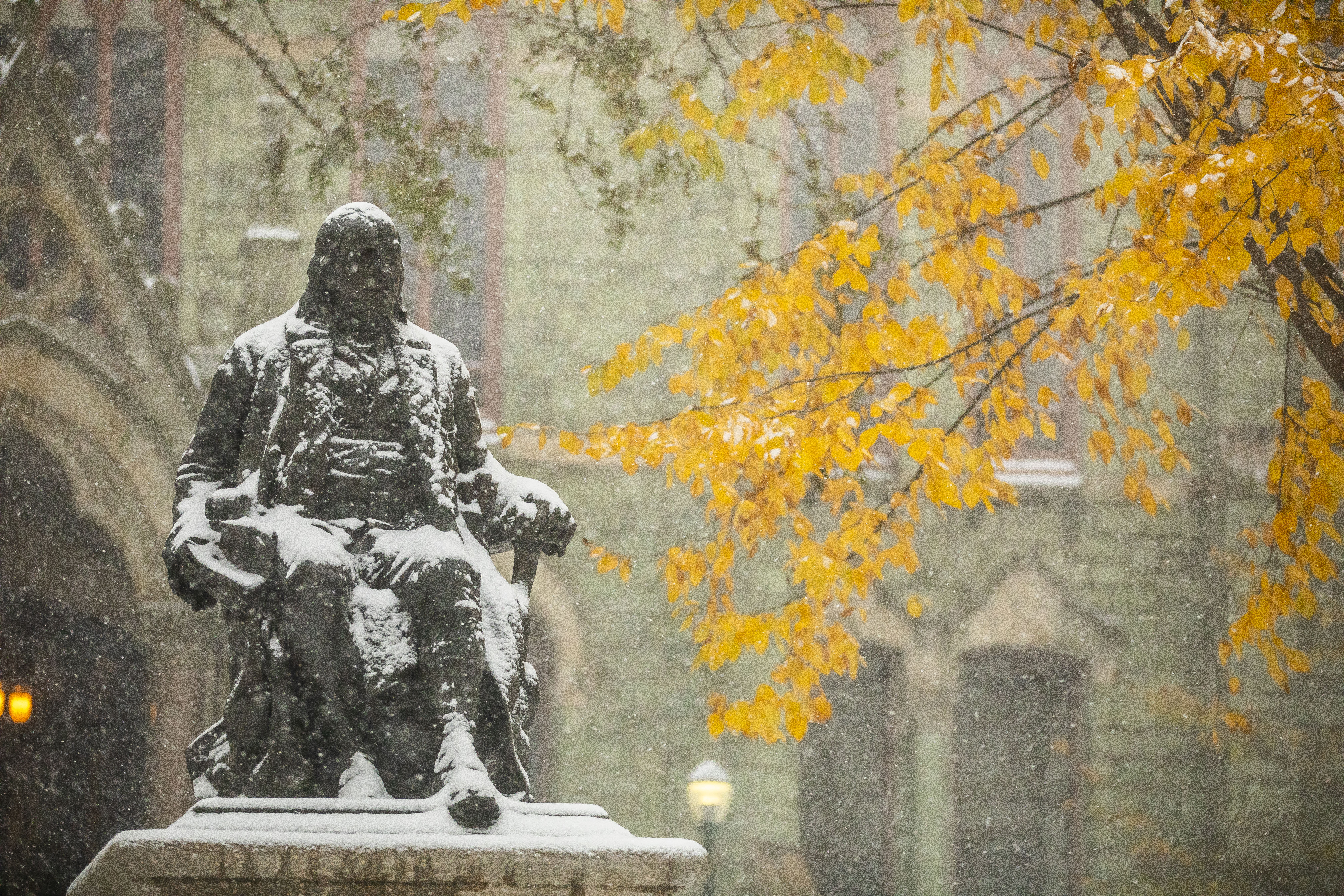 Snow beginning to acculumlate on Ben Franklin statue in front of College Hall