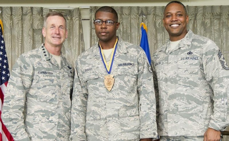 JD Goins in camoflauge uniform getting an award, flanked by two higher ranking Air Force personnel