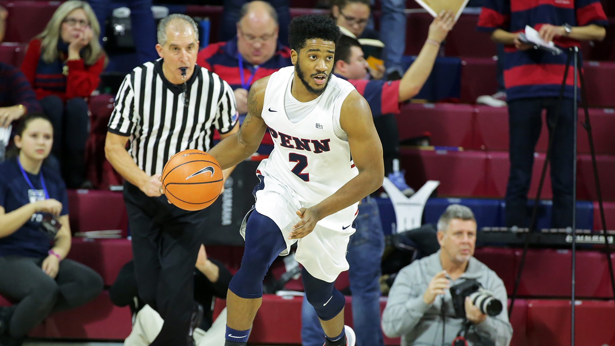 Antonio Woods dribbles down the court