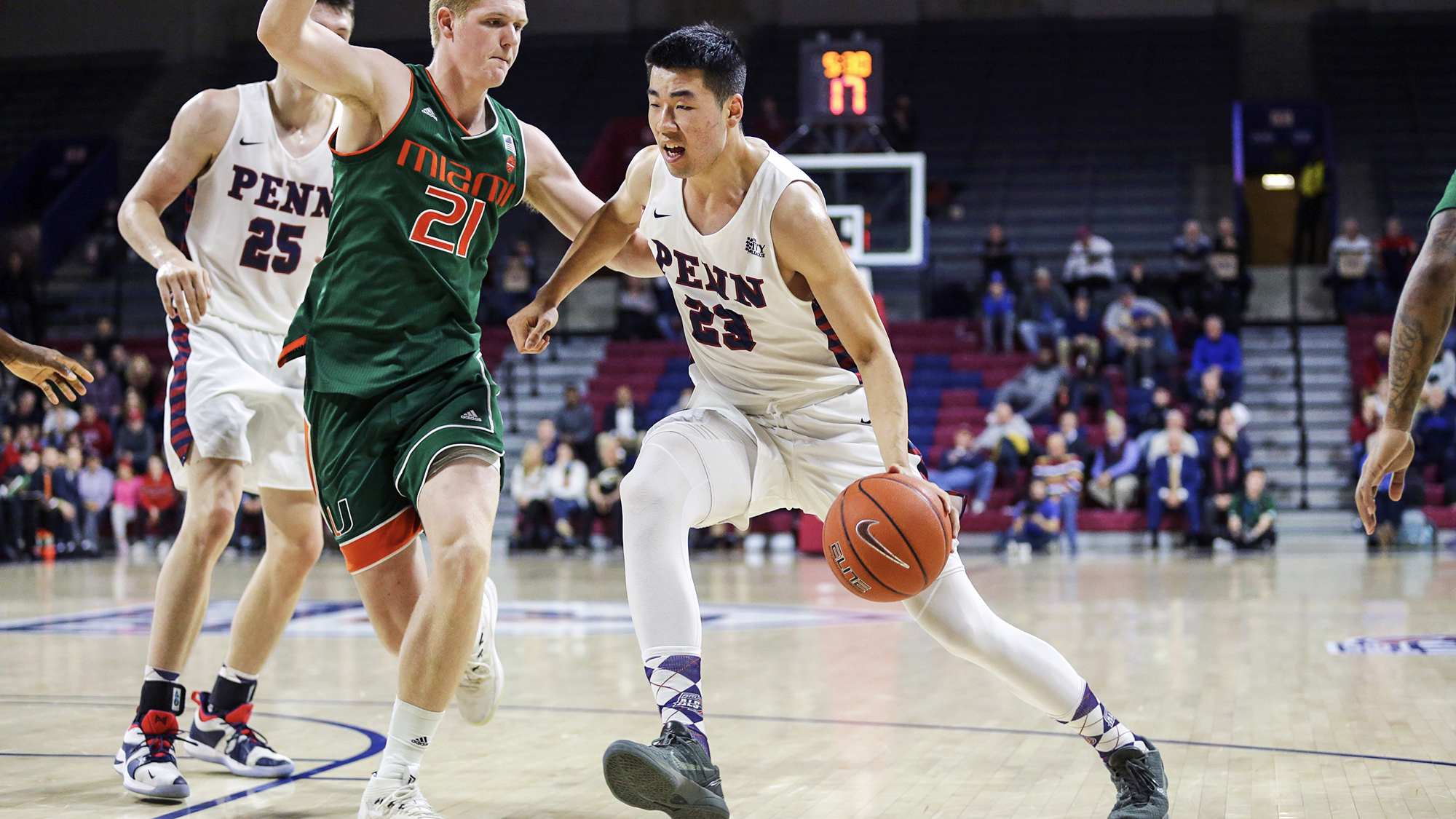 Michael Wang dribbles to the basket versus Miami