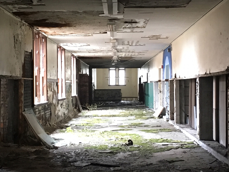 interior of abandoned building with sunlight coming in from windows
