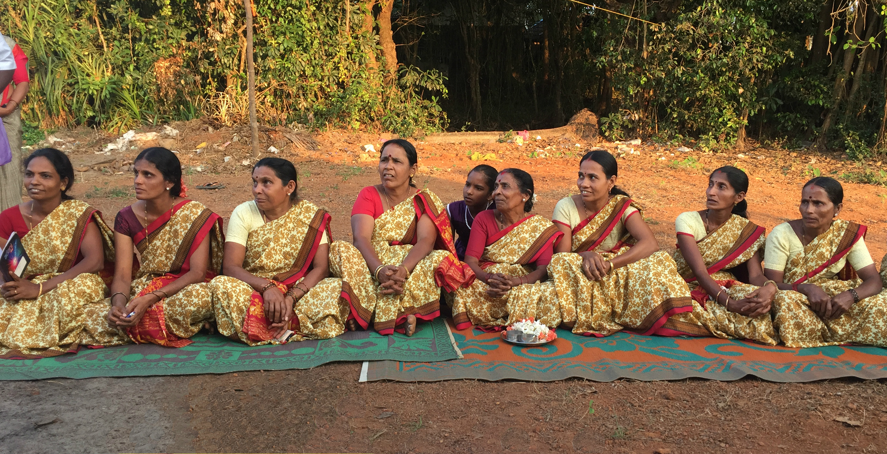 Women from a small self-help group movement in India sit at a community meeting with members of the SP2 research project. 