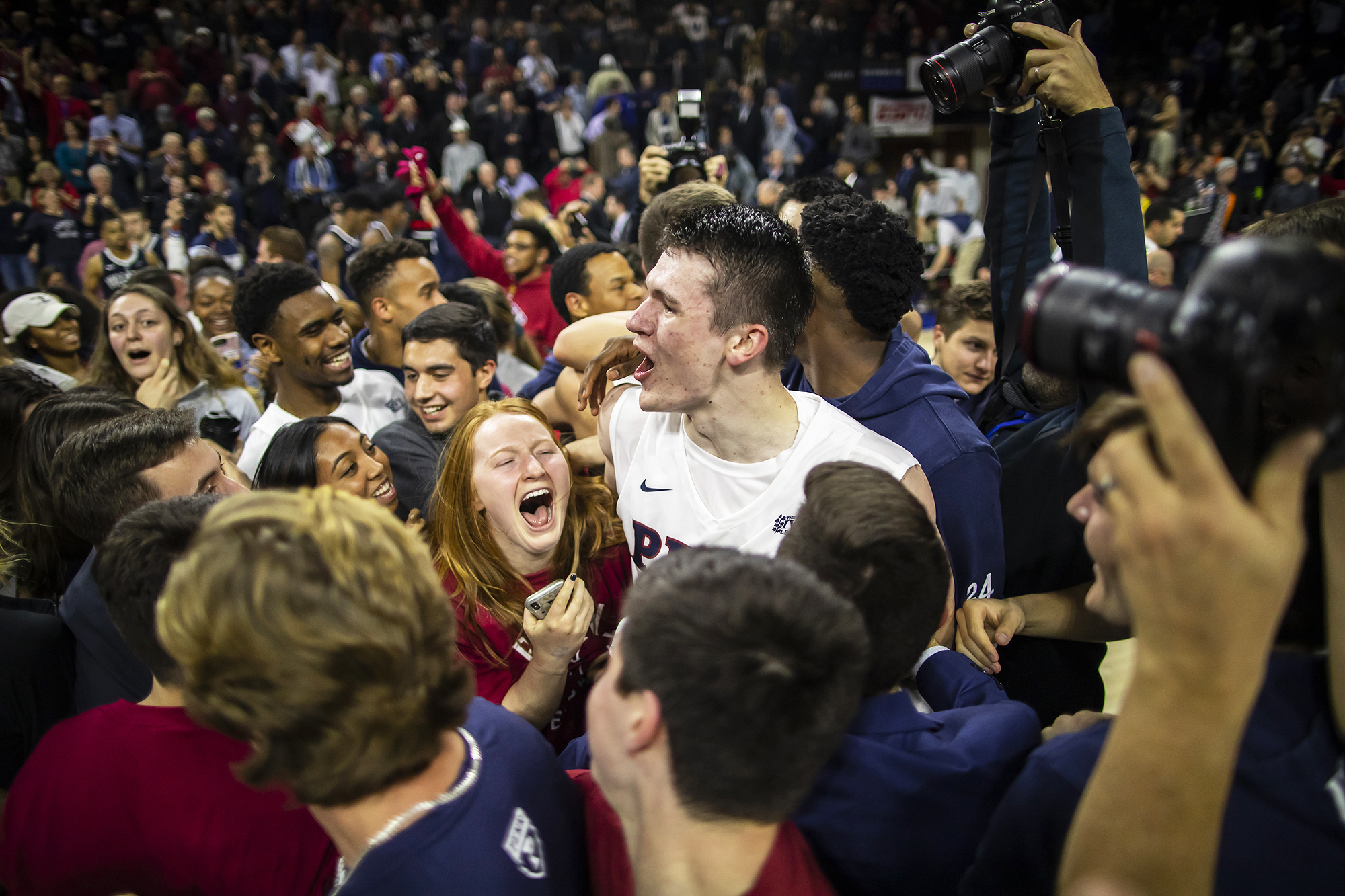 A.J. Brodeur celebrates with fans on the Palestra court after beating Villanova