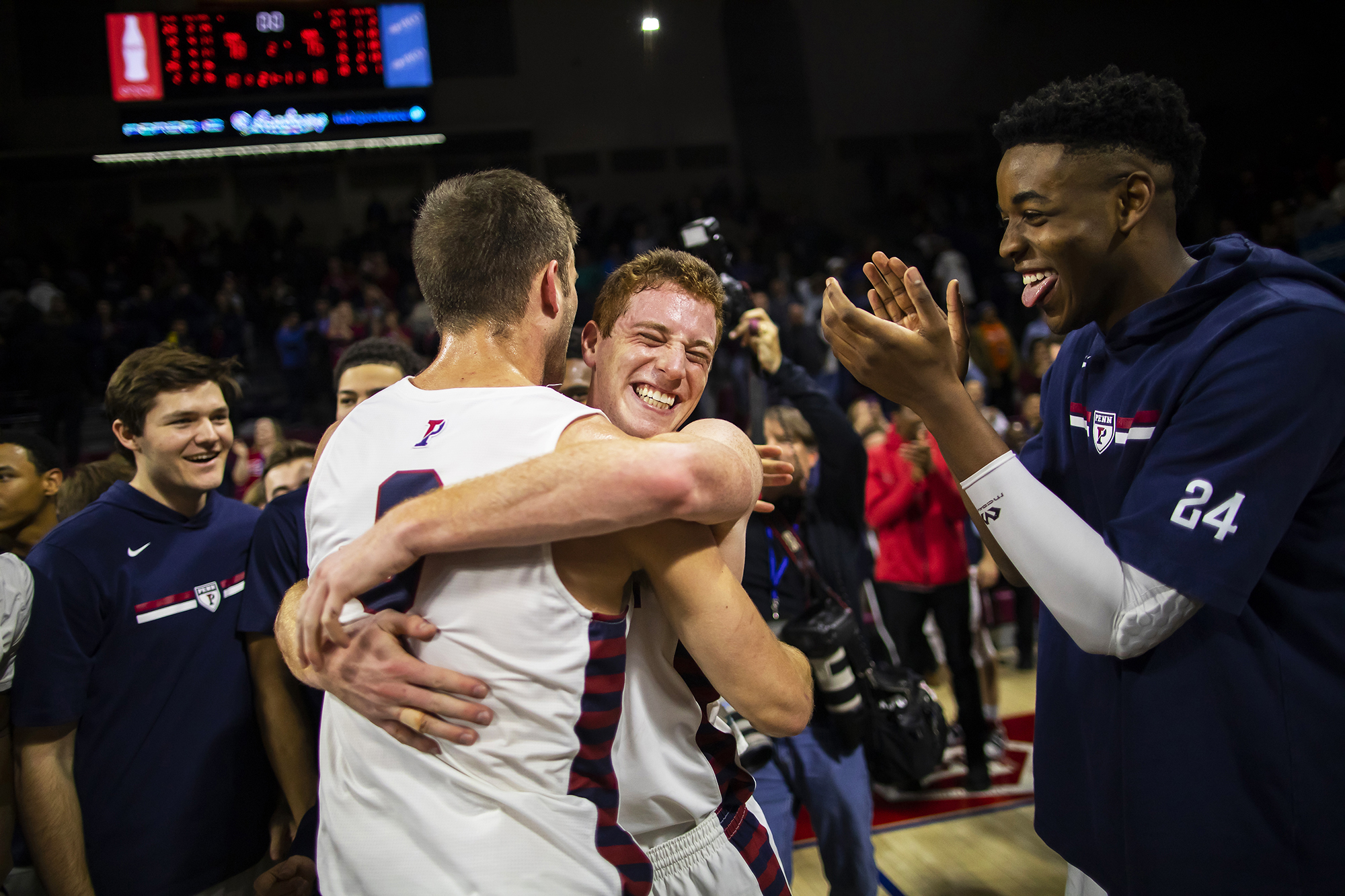 Penn players celebrate on the court after beating Villanova