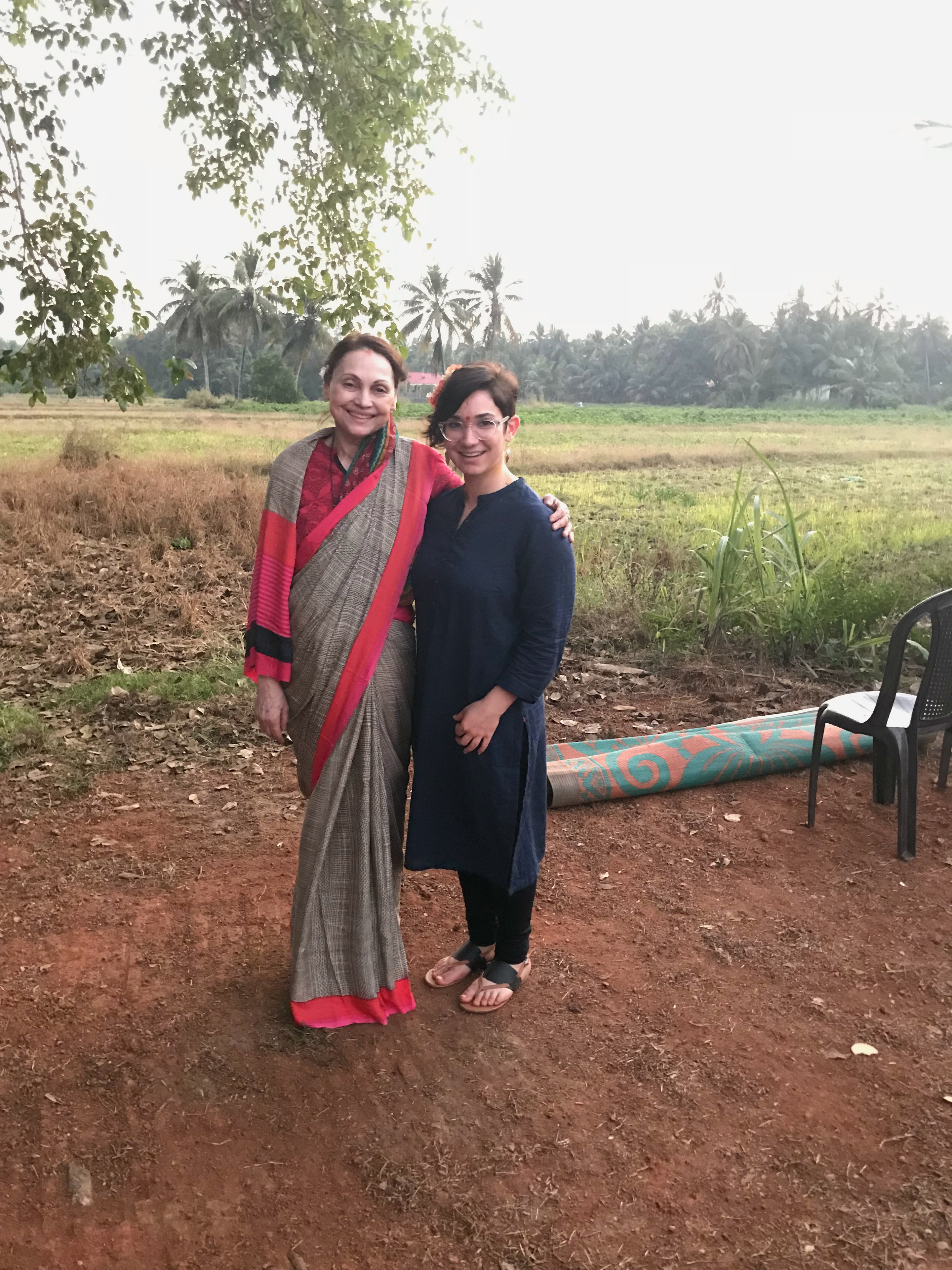 Taking a break during a research project in India, Femida Handy and Allison Russell stand in a field.