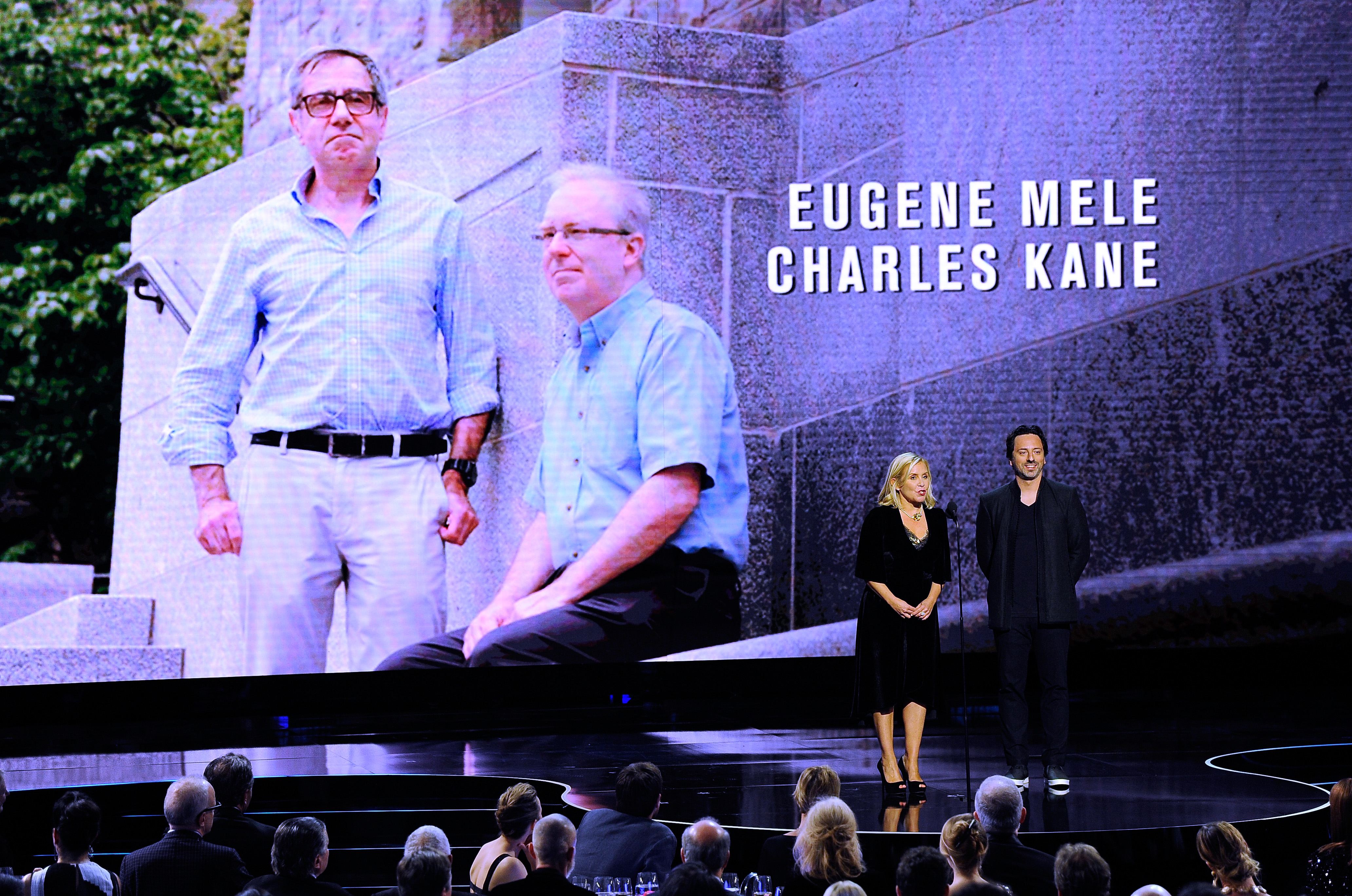 Presentation ceremony with background image of Kane and Mele