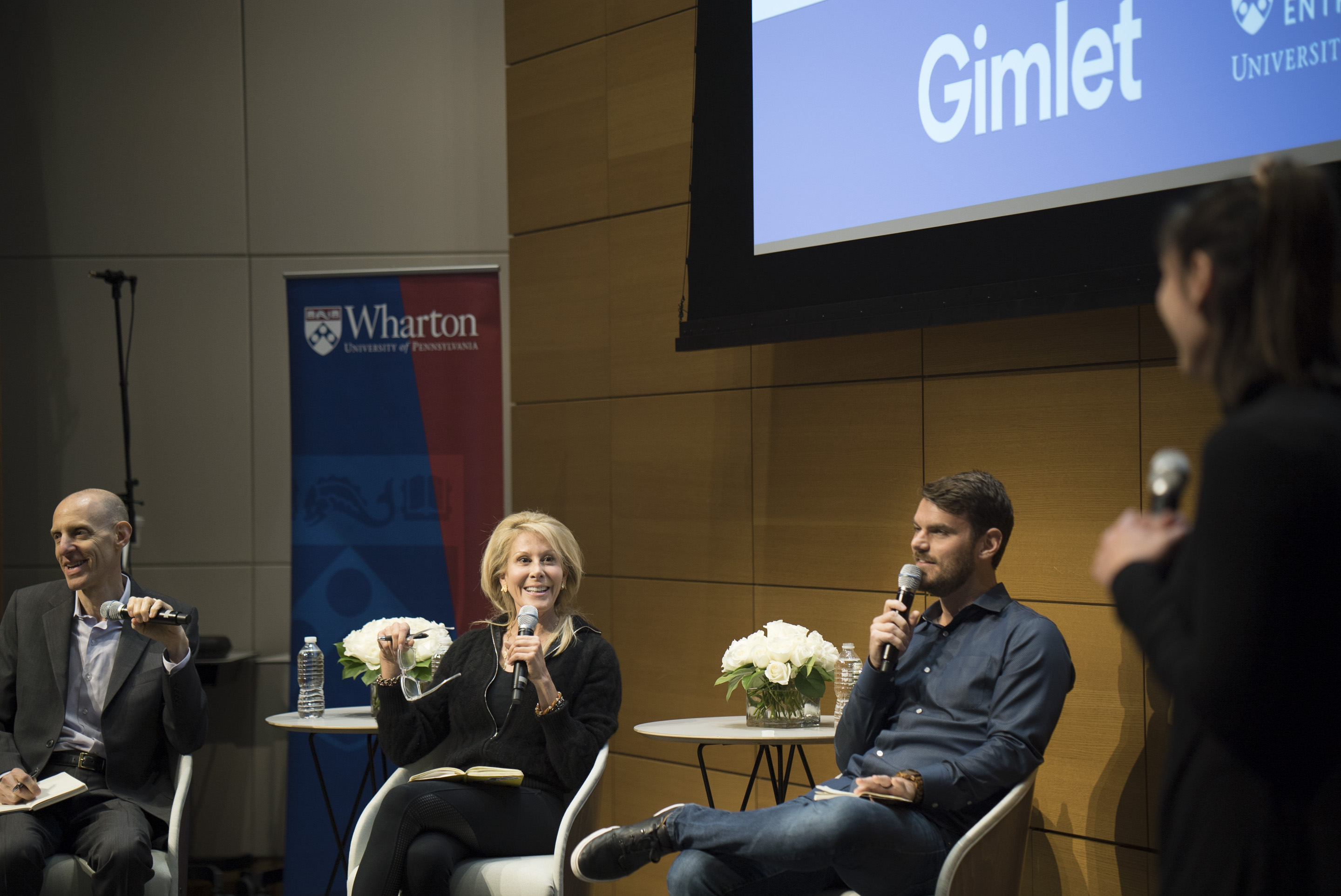 Penn student Katherine Sizov pitches to investors in front of a crowd at Wharton