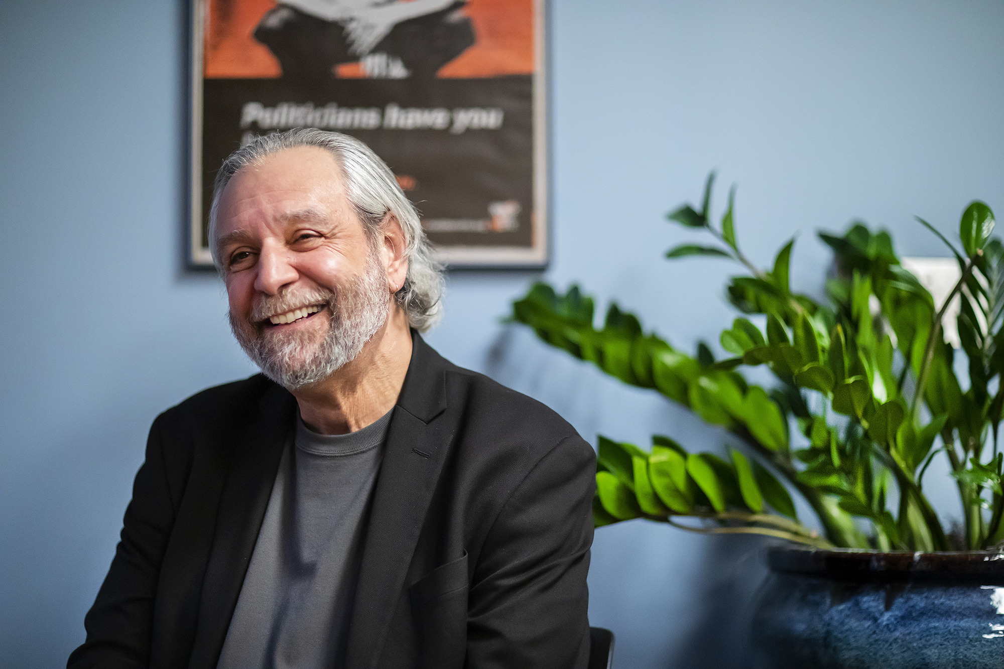 Delli Carpini smiling and chatting in his Annenberg office