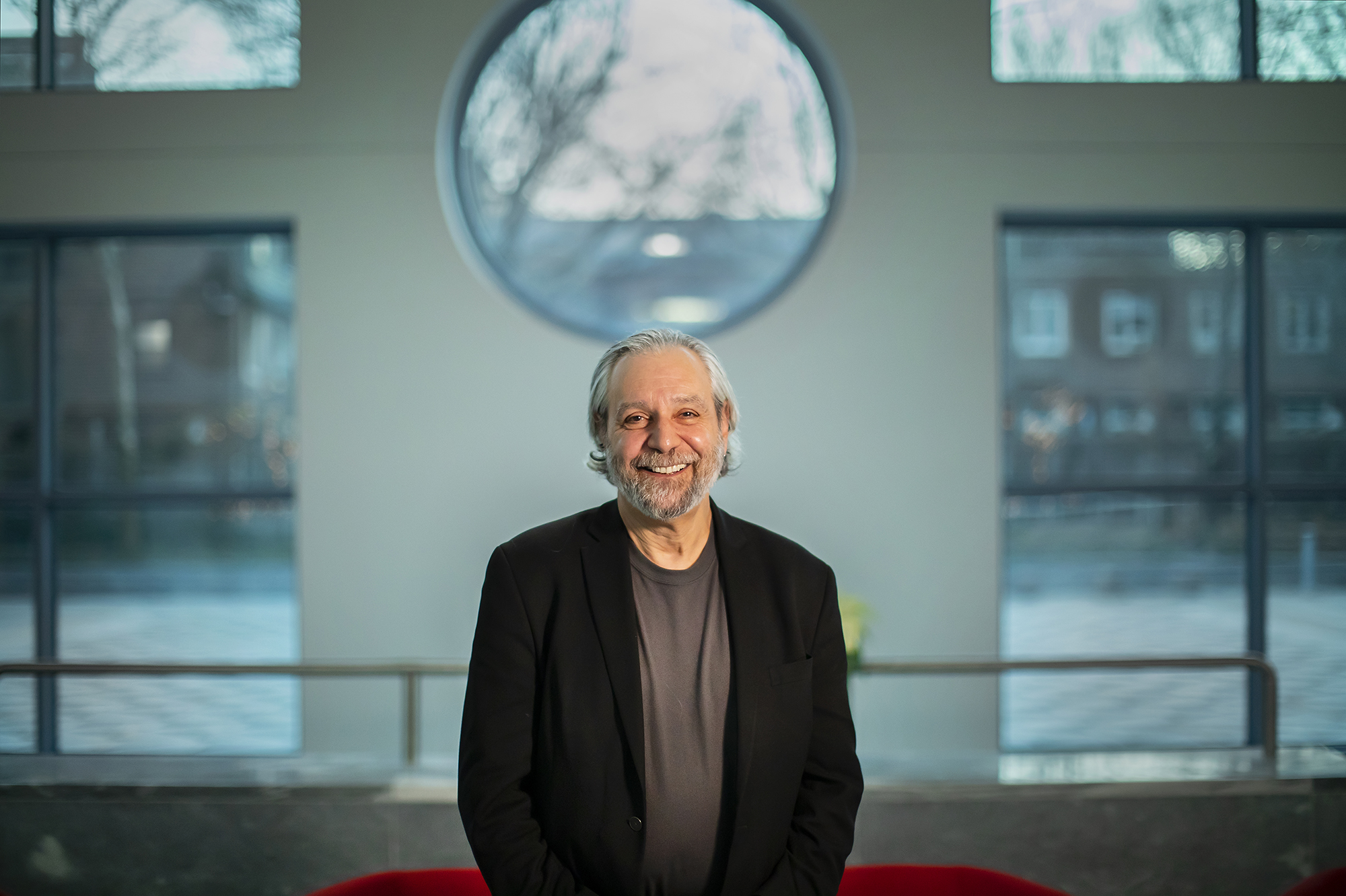 Delli Carpini stands in Annenberg lobby, in front of windows