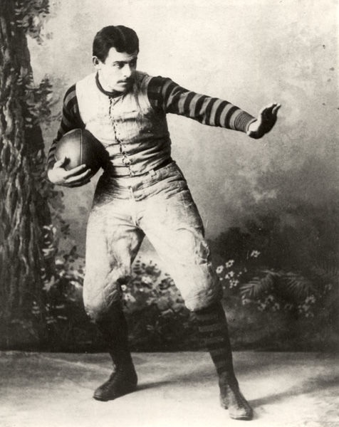 John Heisman poses holding a football at Penn in 1891
