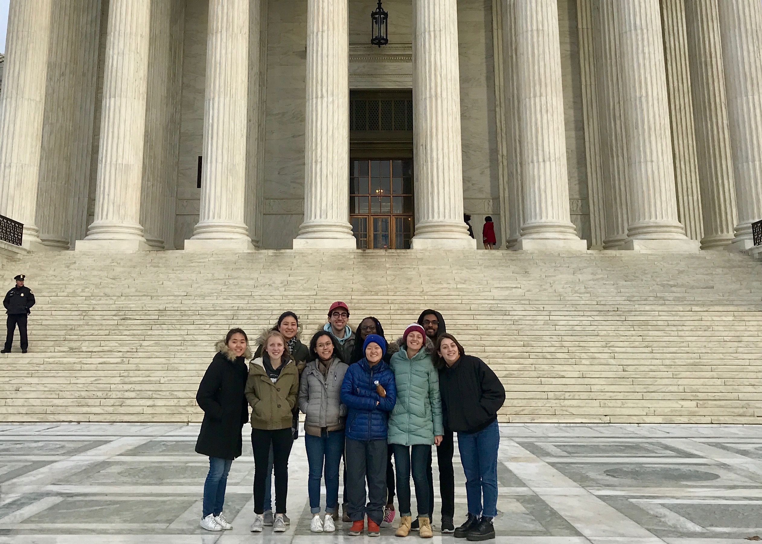Ten students standing in front of the steps of the Supreme Court building in Washington, D.C.