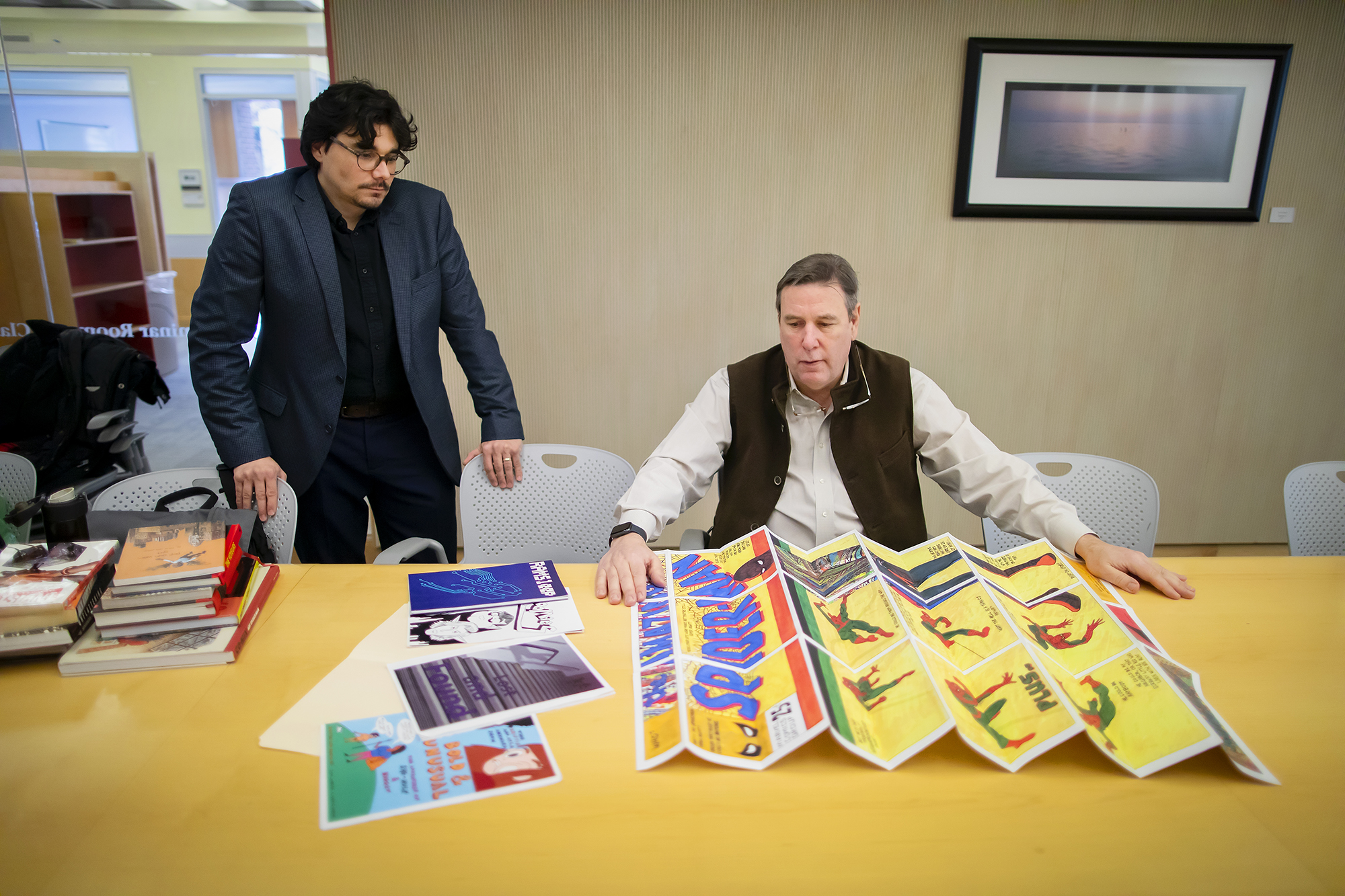 Cloutier and Berry in a conference room with foldout Spider-Man comic