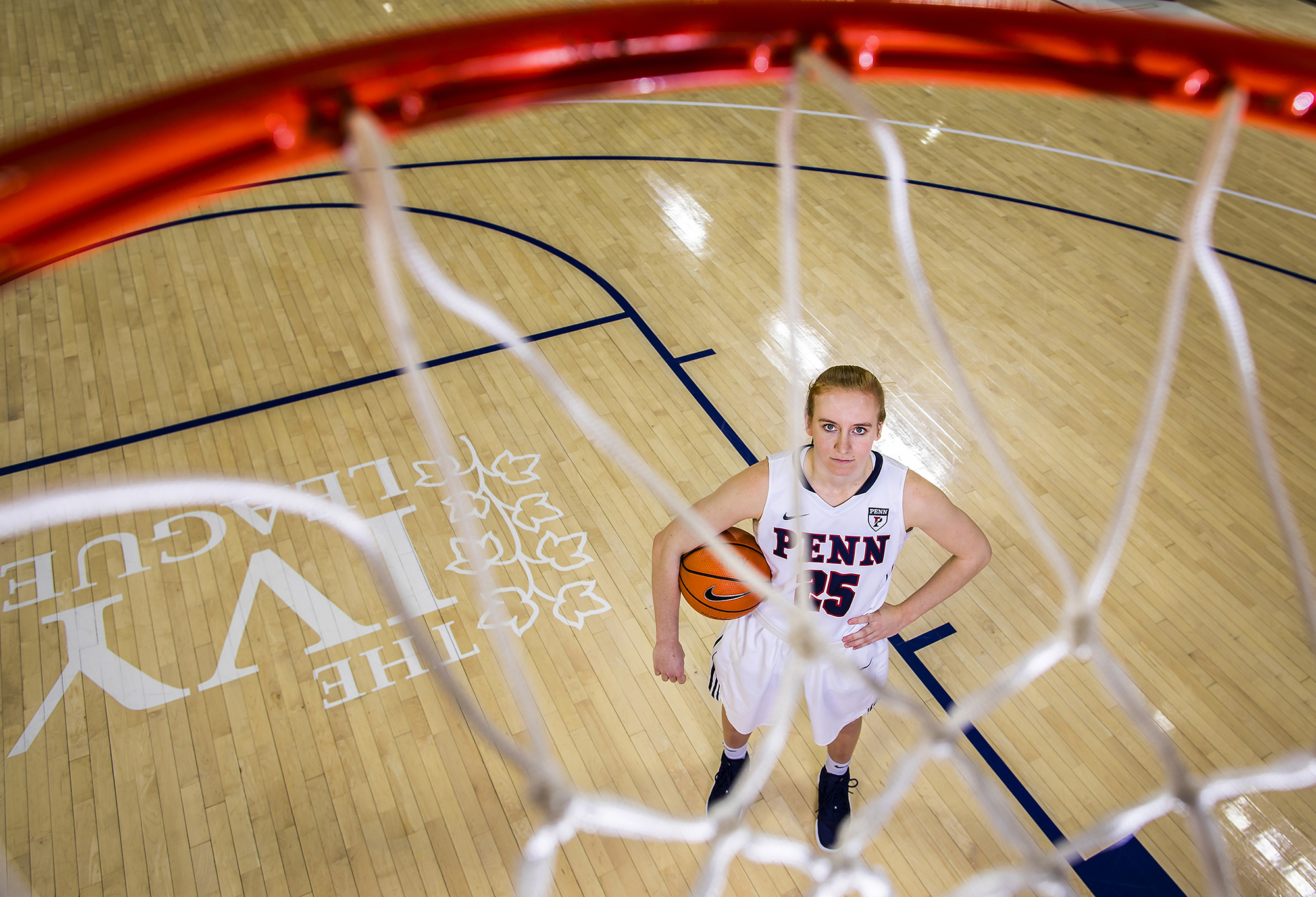 Ashley Russell of the women's basketball team poses with a ball on the Palestra court.