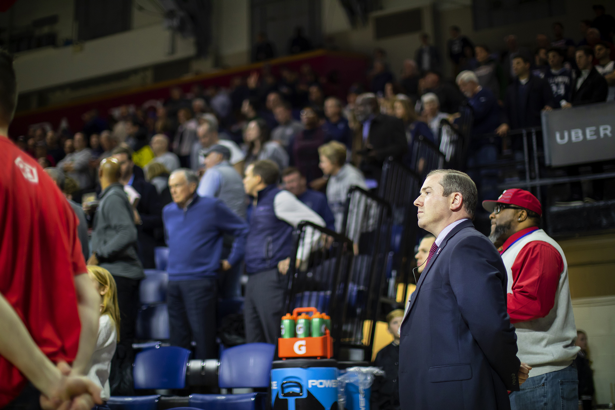 Director of Gameday Operations Mike Martin stands at attention in the Palestra.