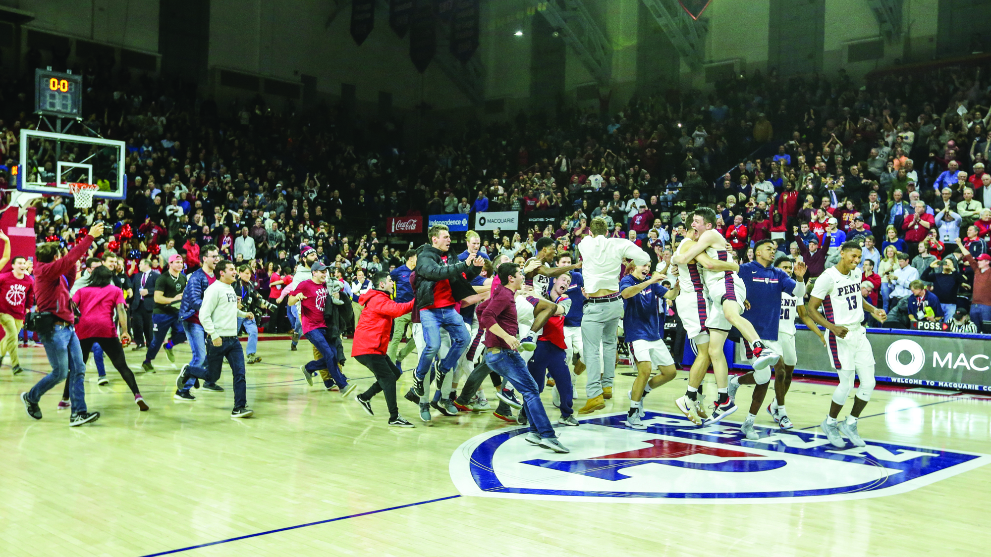 Penn players and fans rush the court after beating Villanova