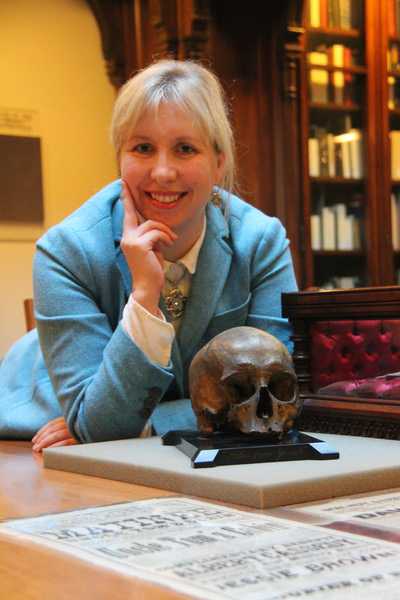 Librarian with skull that has been used as a theater prop. 