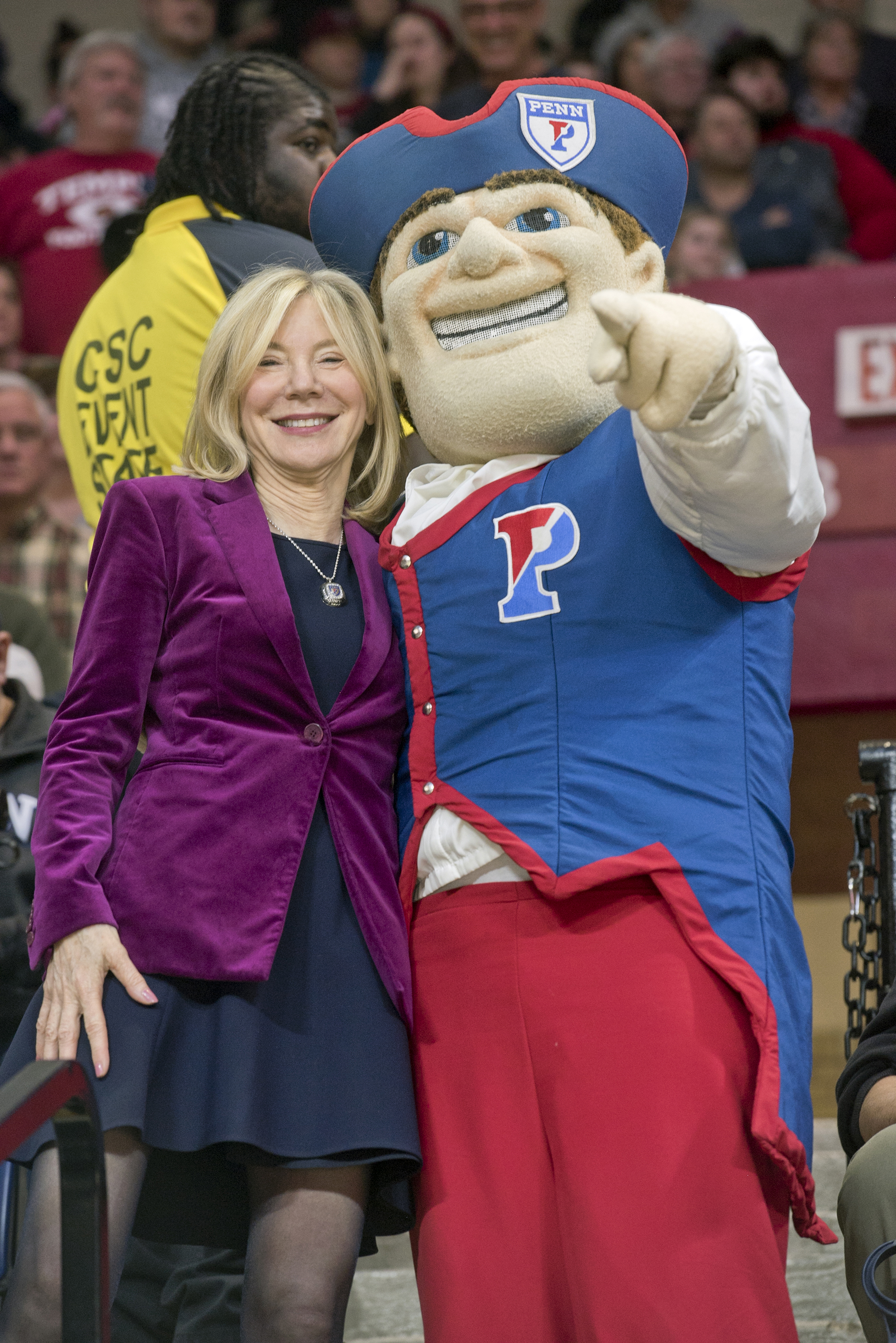 President Amy Gutmann and the Penn Quaker mascot in the Palestra at the Penn vs. Princeton game.