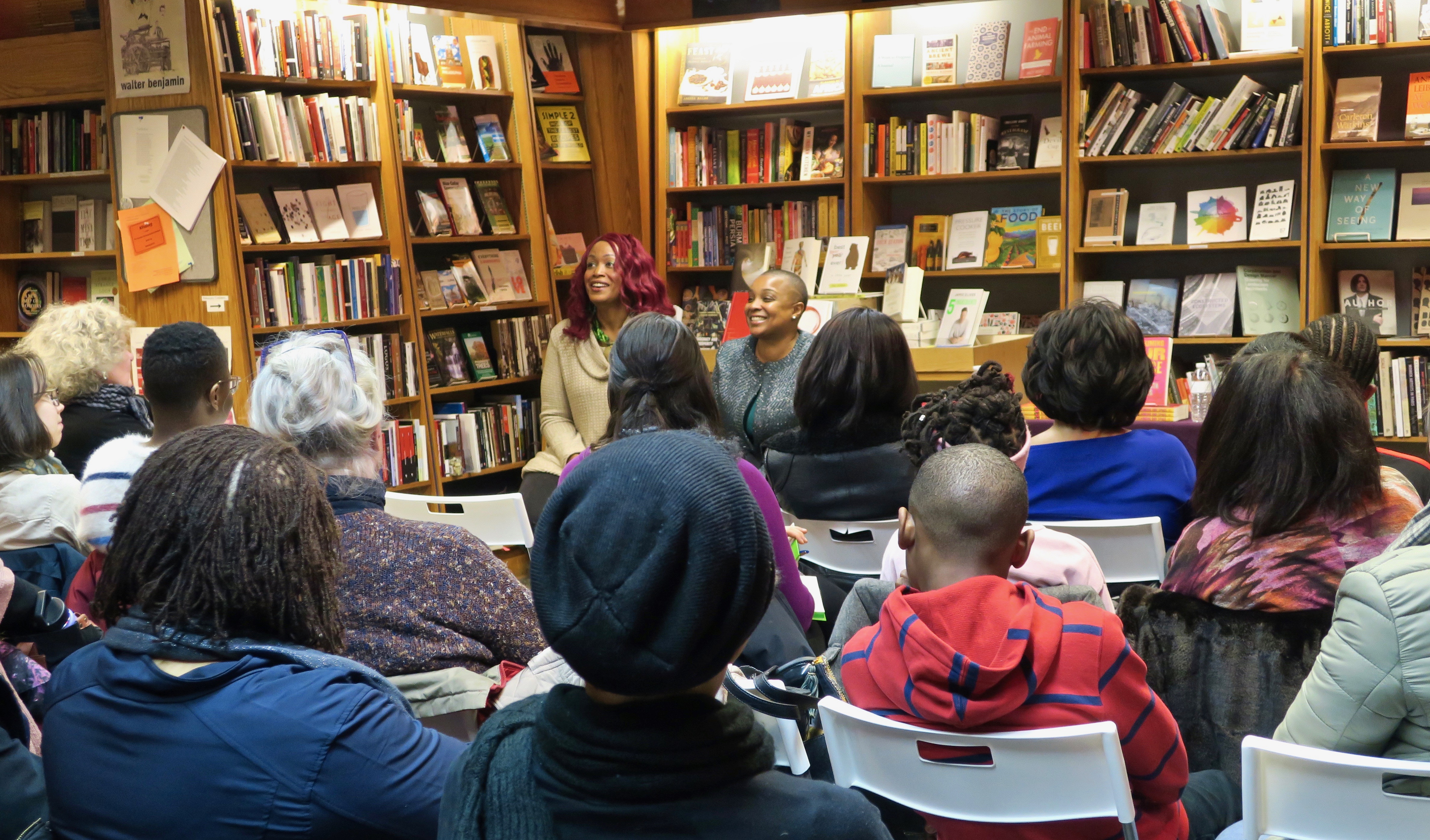 Feminista Jones and Tanji Gilliam seated in front of a small crowd at the Penn Book Center