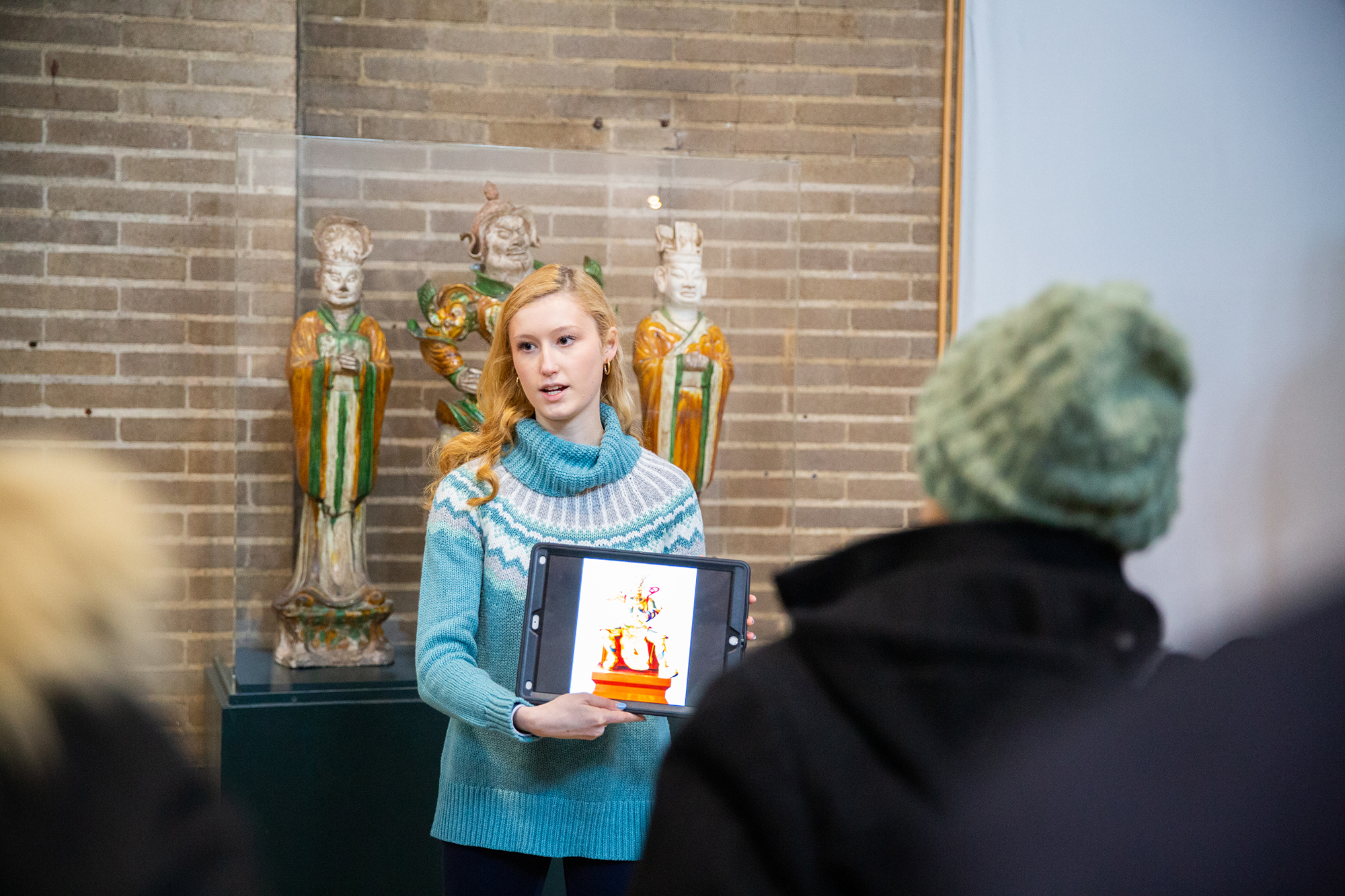 Susan Radov leads a tour of the China Gallery with sculptures in the background