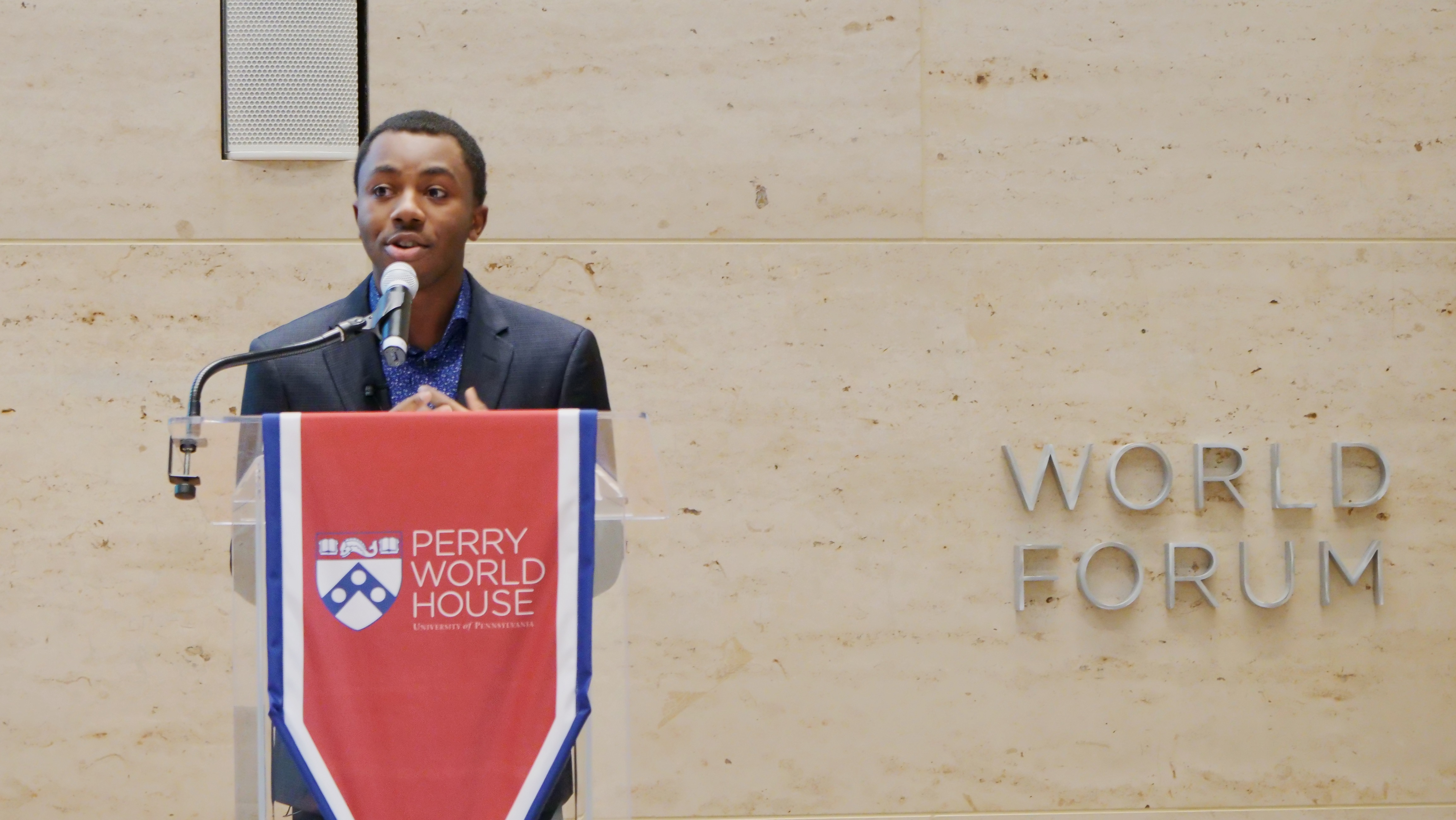 Student Sonari Chidi speaking at Perry World House podium.