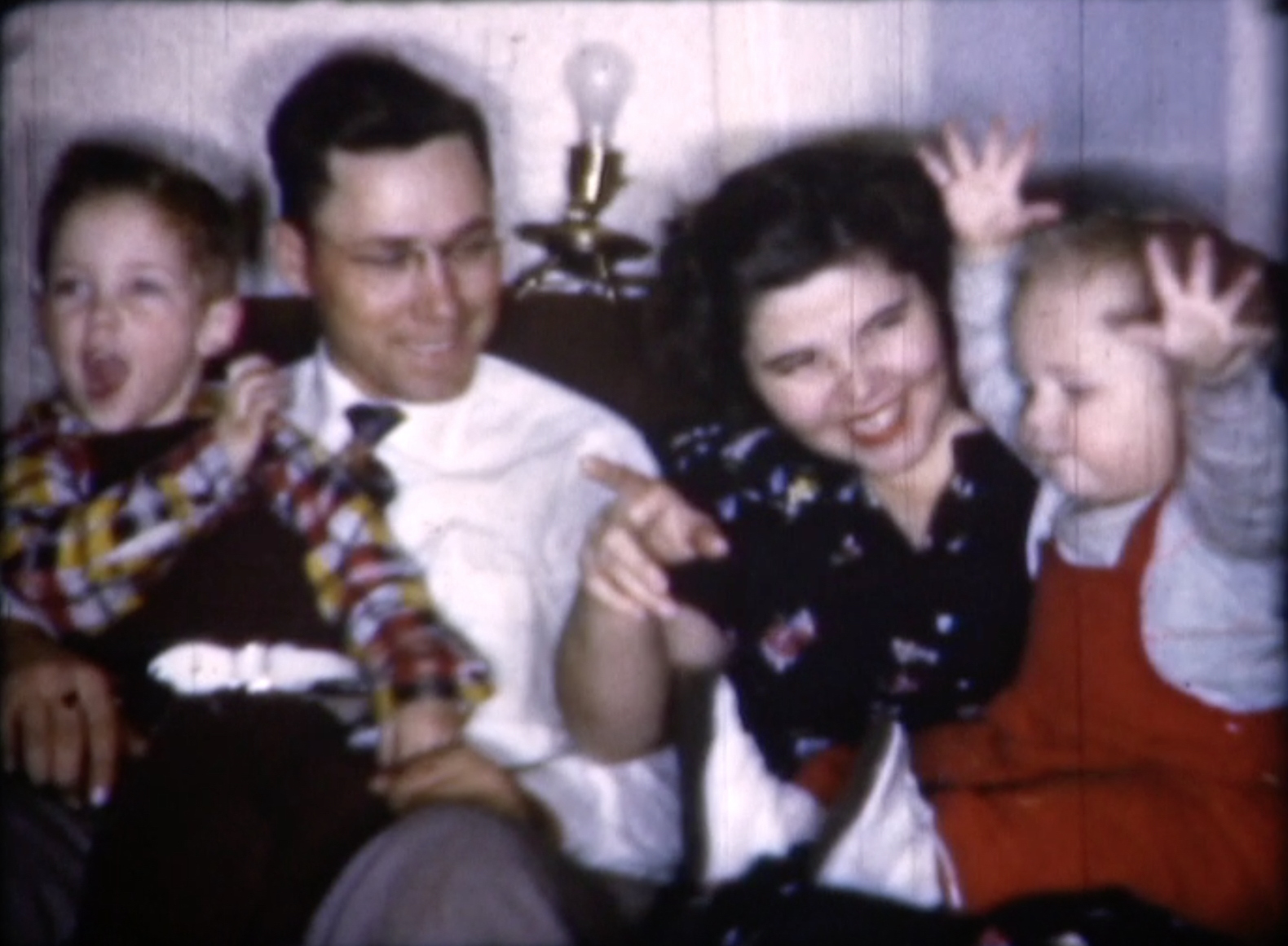 Family gathered on couch, smiling