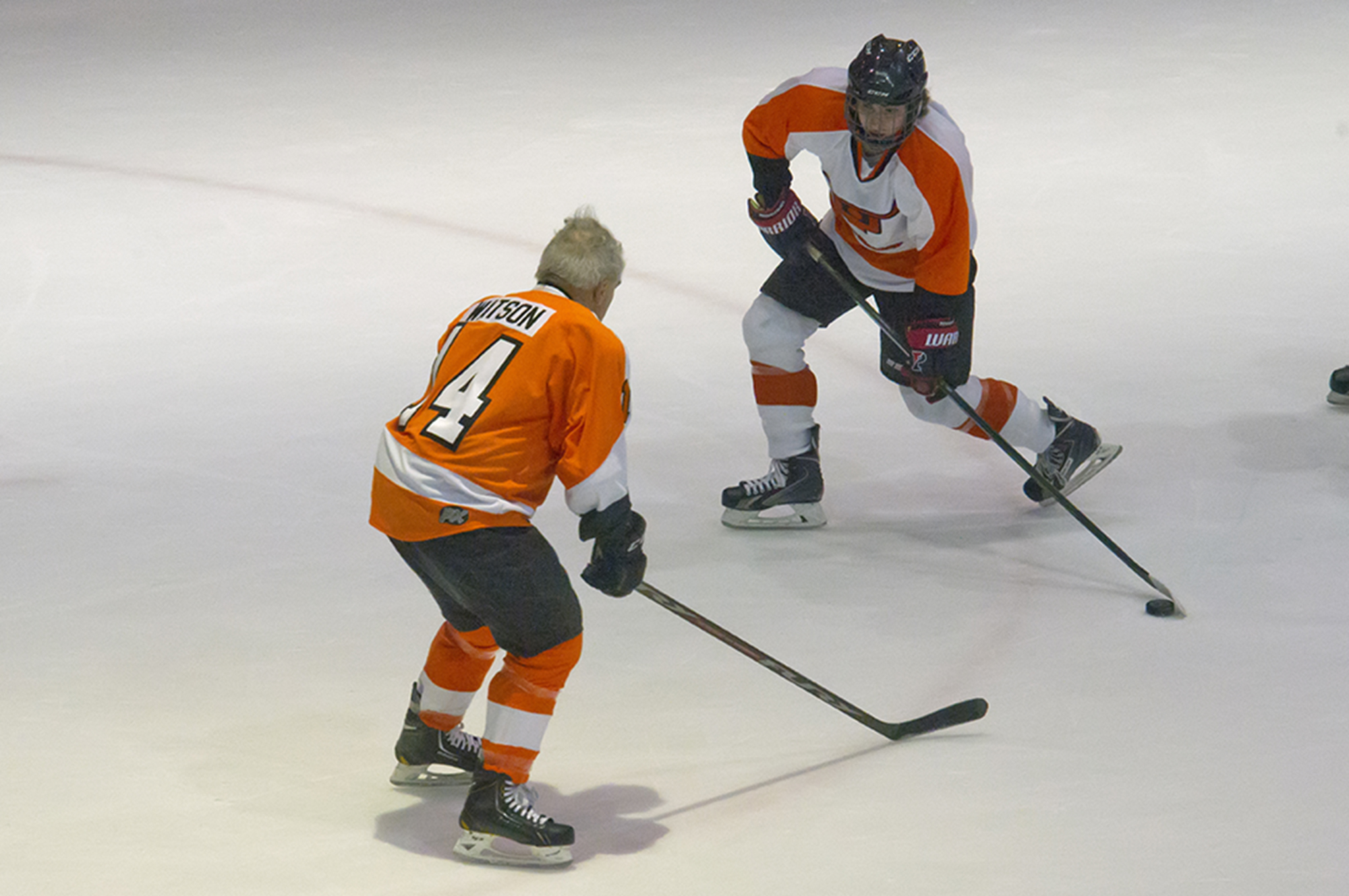 A Flyers alum on ice against a Snider team player
