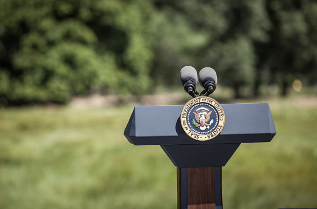 Empty podium with POTUS seal on lawn