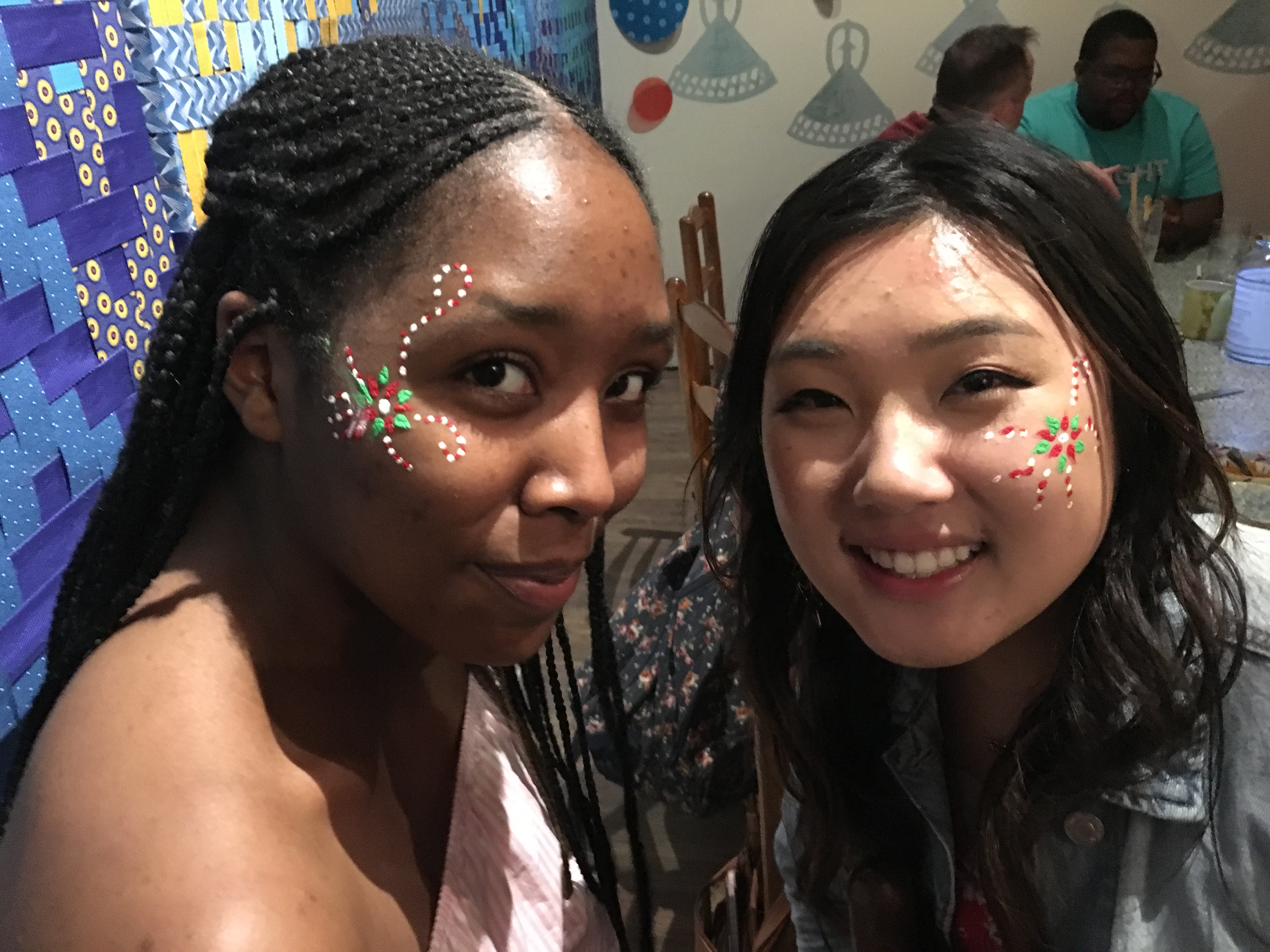 Two students with colorful face paint. 