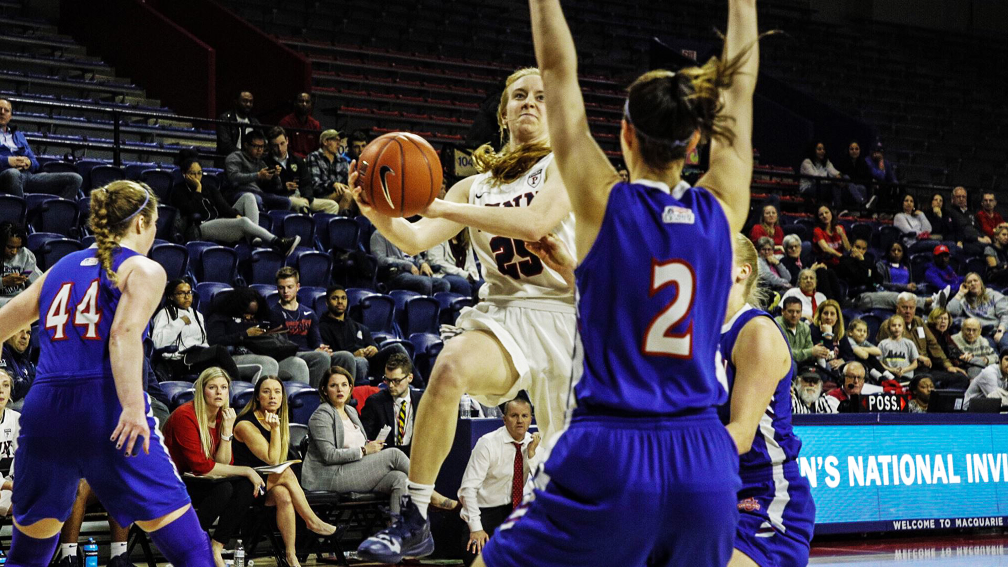 Ashley Russell drives to the basket against American in the WNIT.