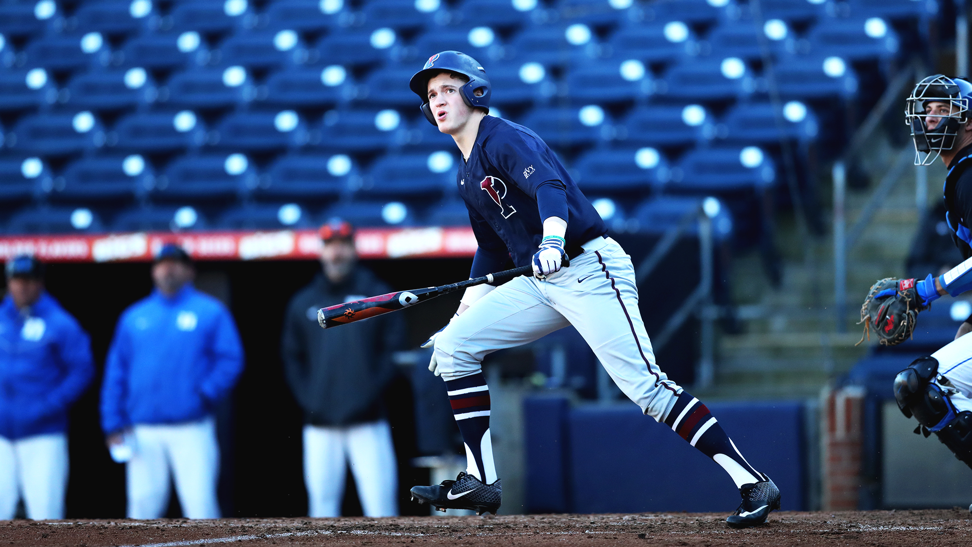 Sophomore infielder Eduardo Malinowski watches the ball from the batters box after a hit.