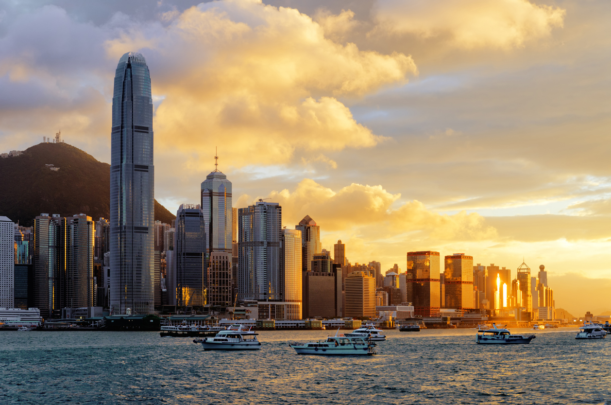 Hong Kong skyline as sun sets over its port